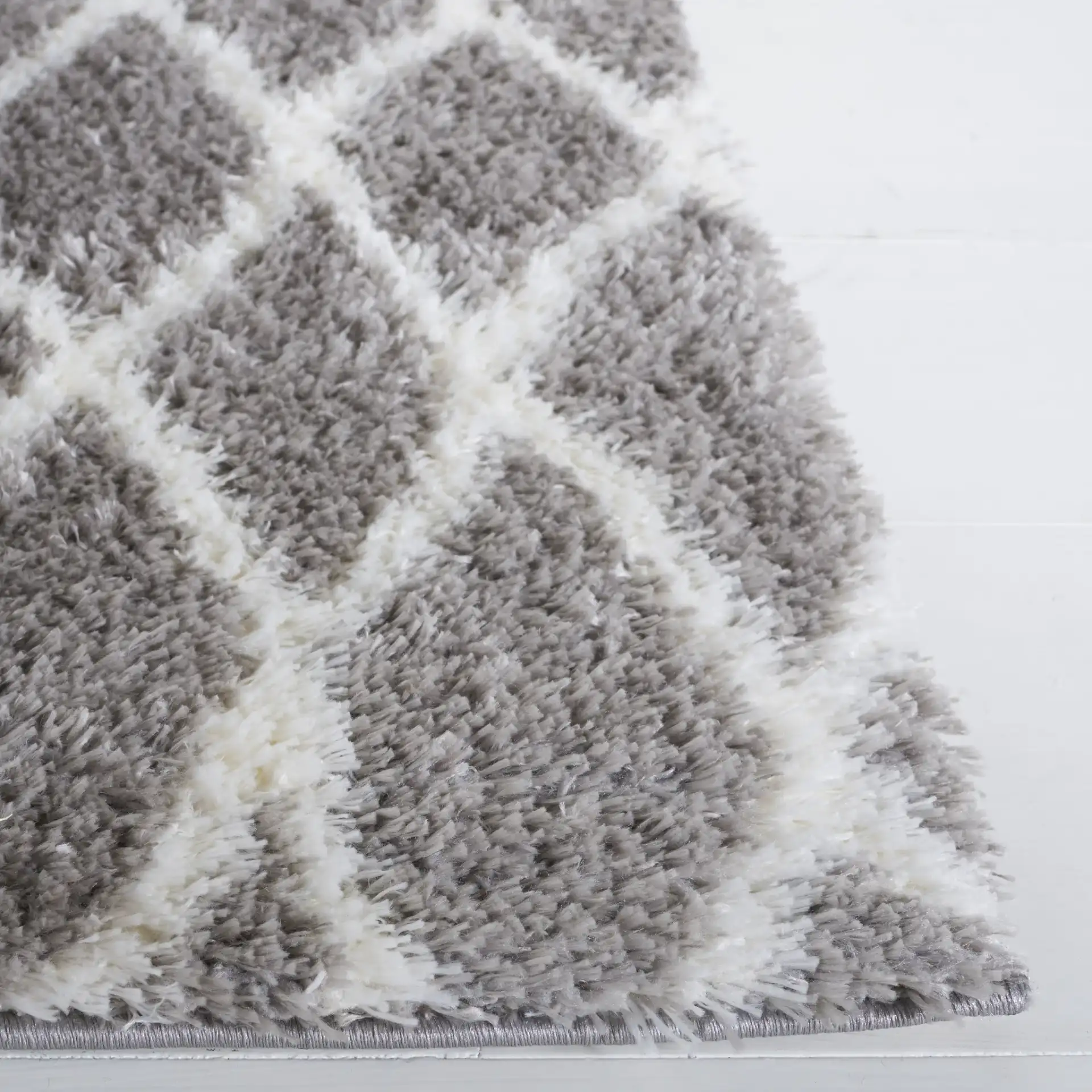 Tahoe Elongated Diamond Shag Rug in Gray / White in a styled room