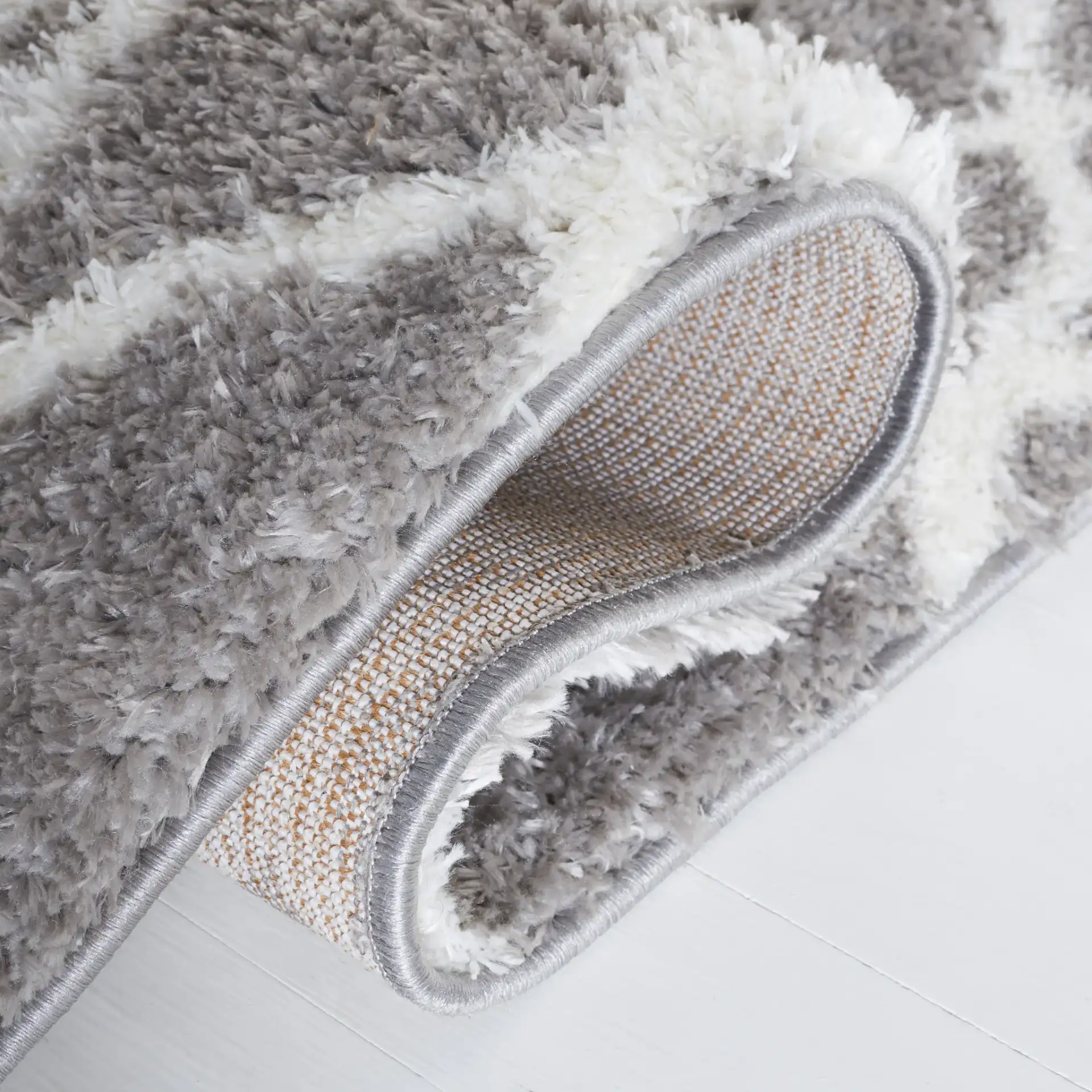 Tahoe Elongated Diamond Shag Rug in Gray / White in a styled room