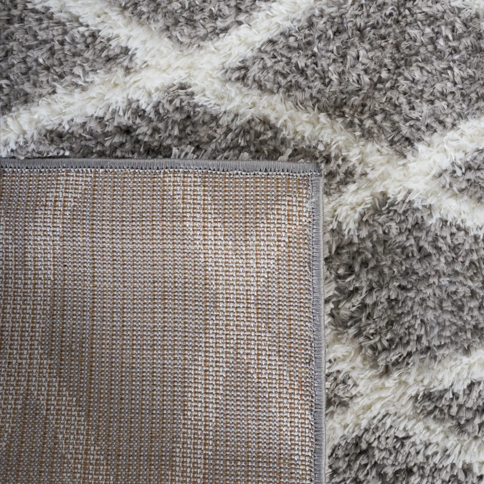 Tahoe Elongated Diamond Shag Rug in Gray / White in a styled room