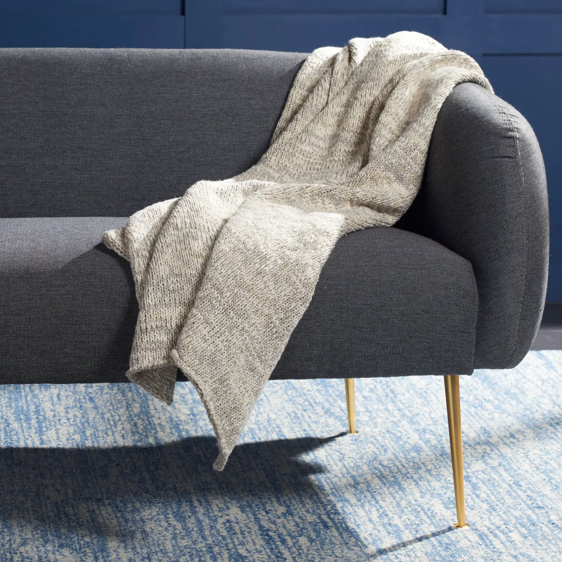 Panna Knit Throw in Gray in a styled room