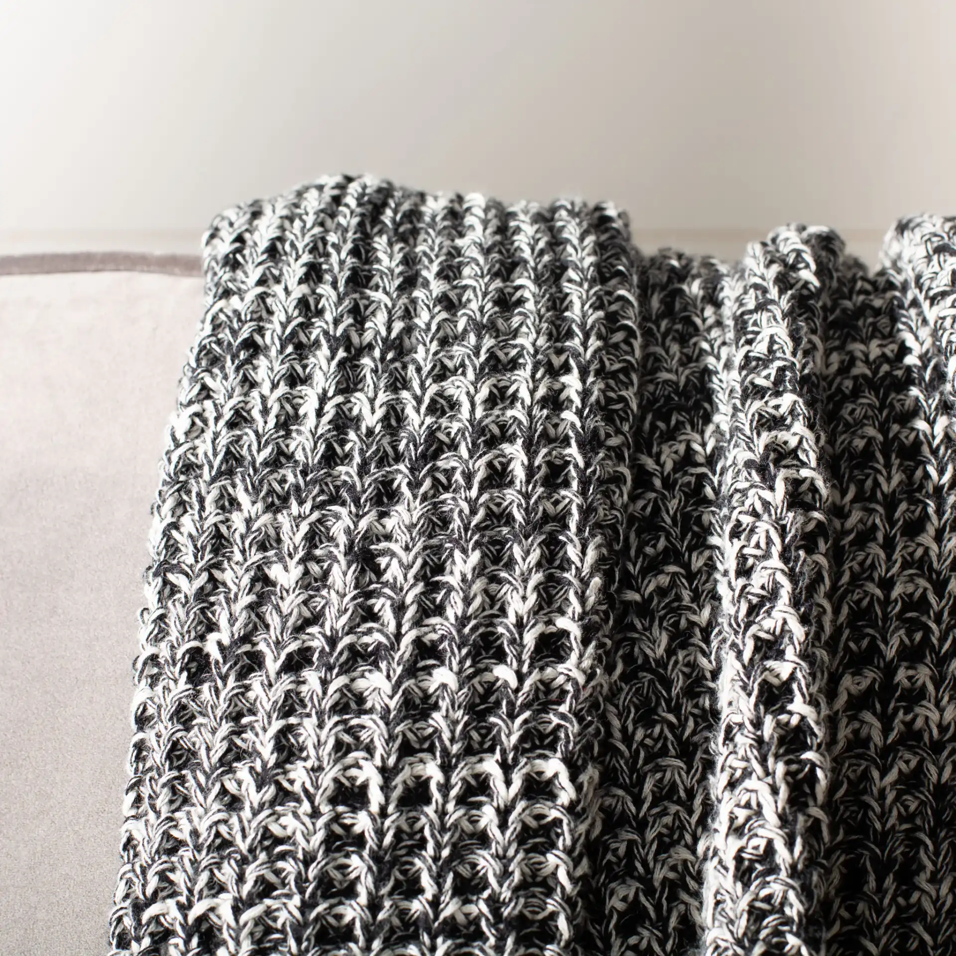 Tensley Throw in Black / Natural in a styled room