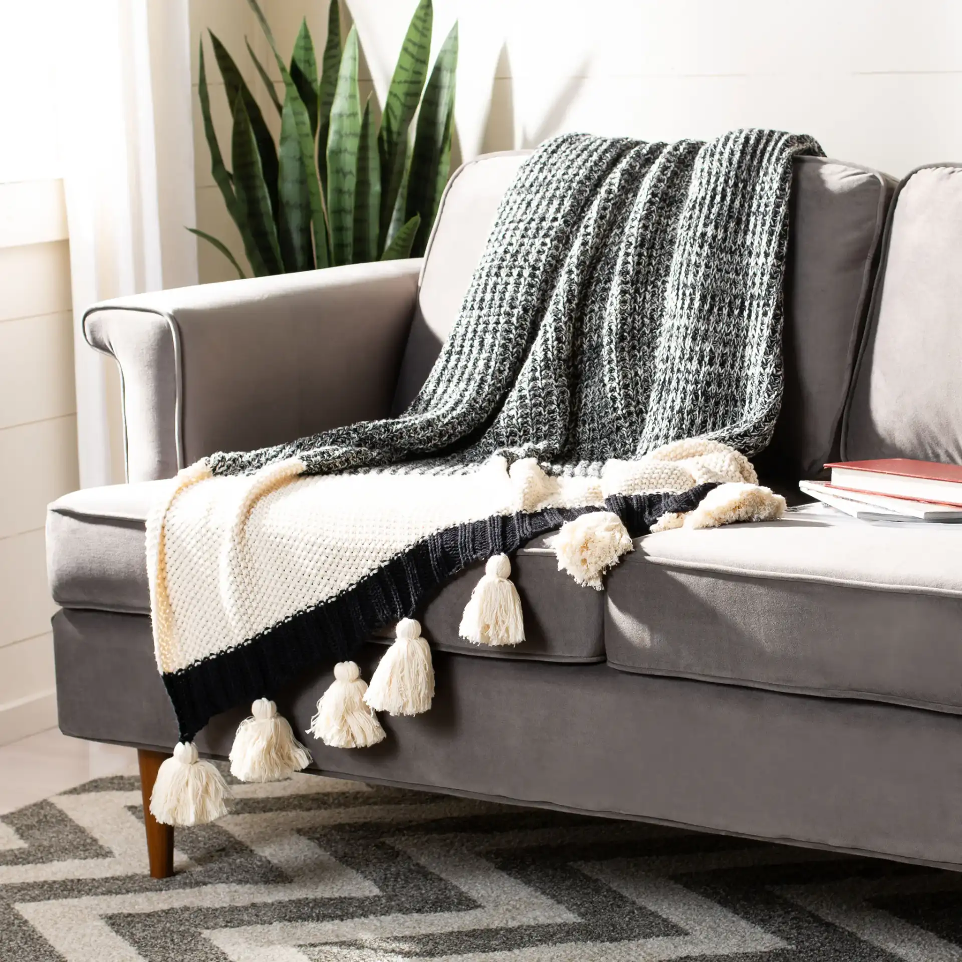 Tensley Throw in Black / Natural in a styled room