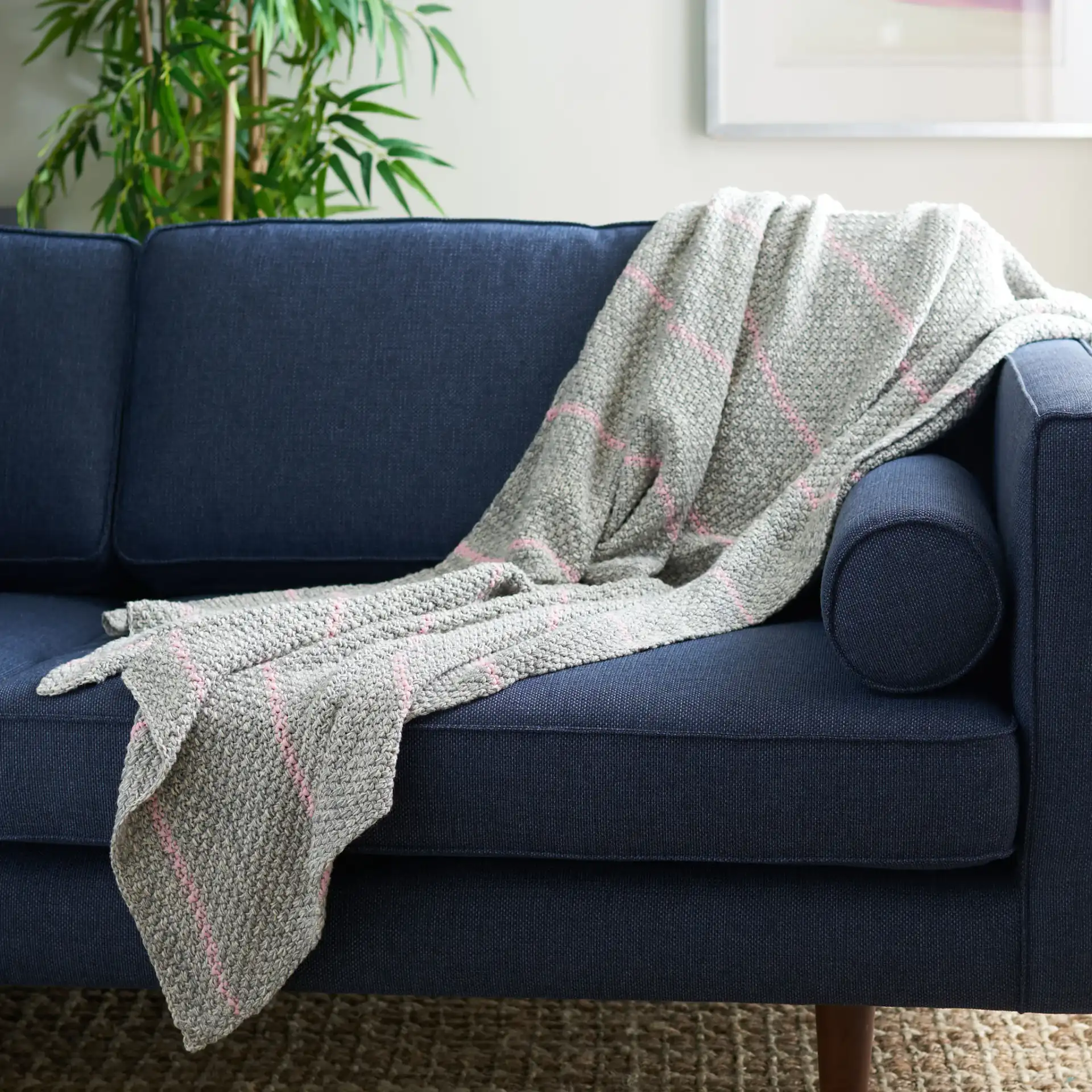 Cassian Throw in Pink / Gray in a styled room