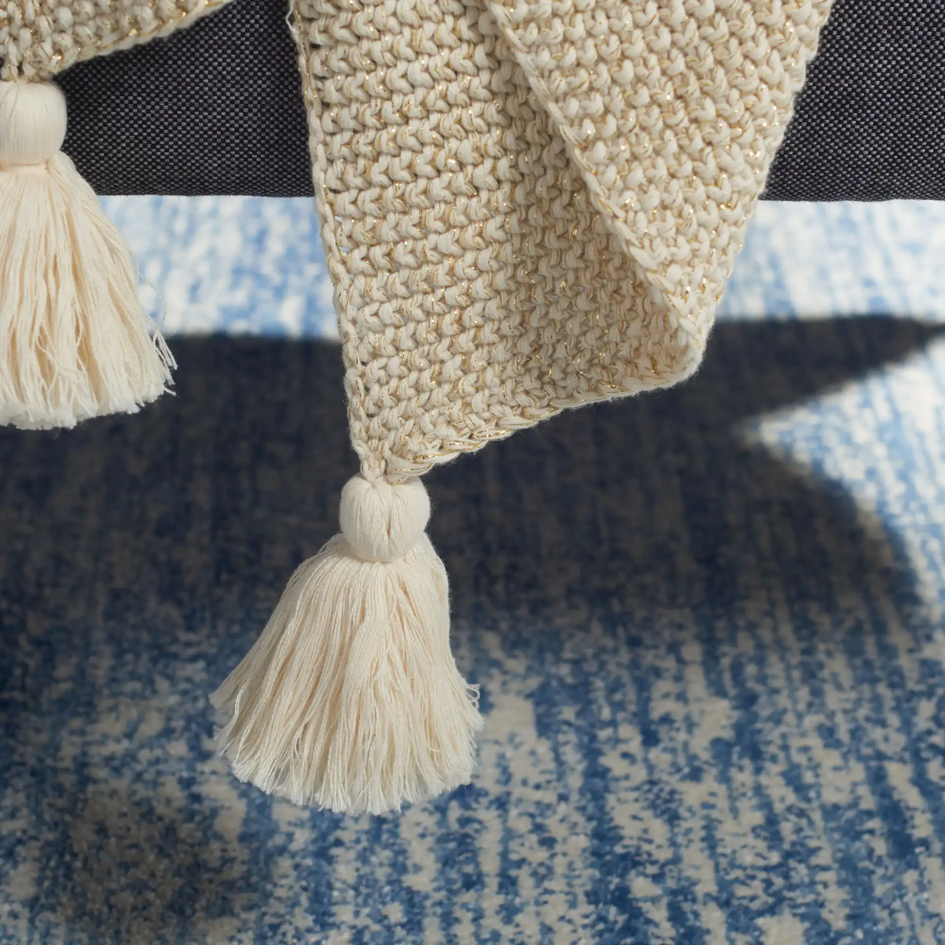 Mari Throw in Beige / Gold in a styled room