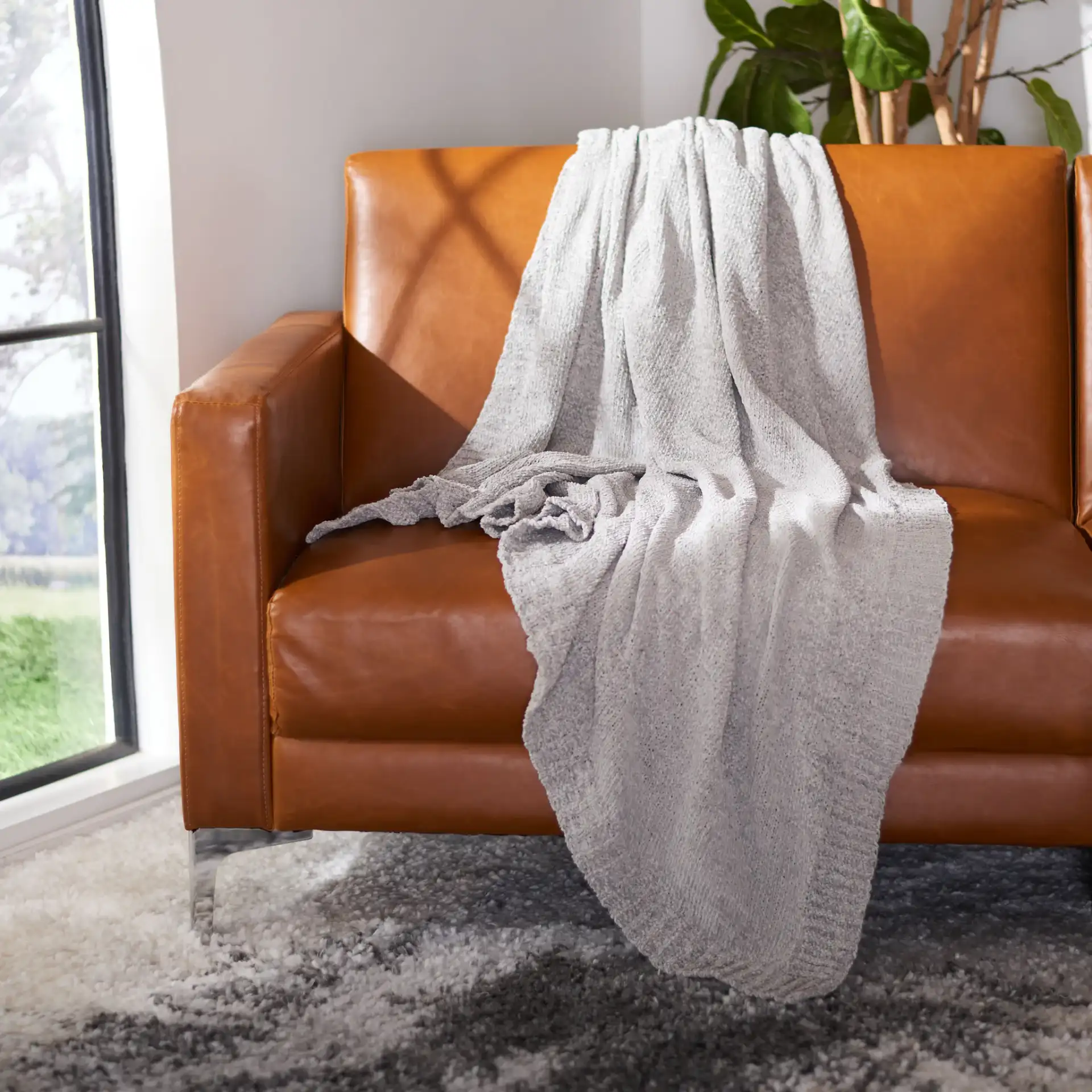 Brynna Throw in Light Gray in a styled room