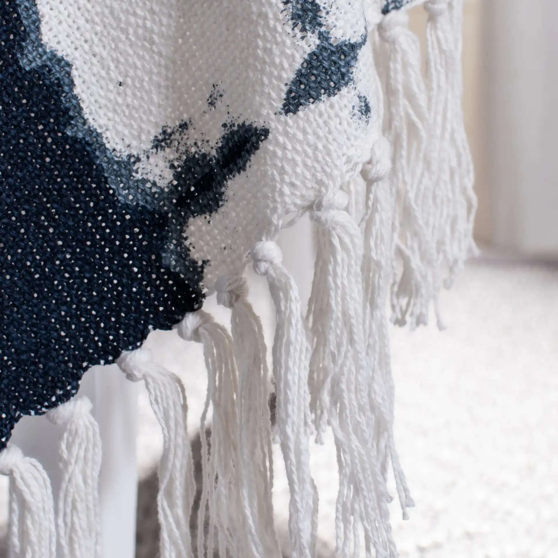 Arya Throw in Beige / Navy in a styled room