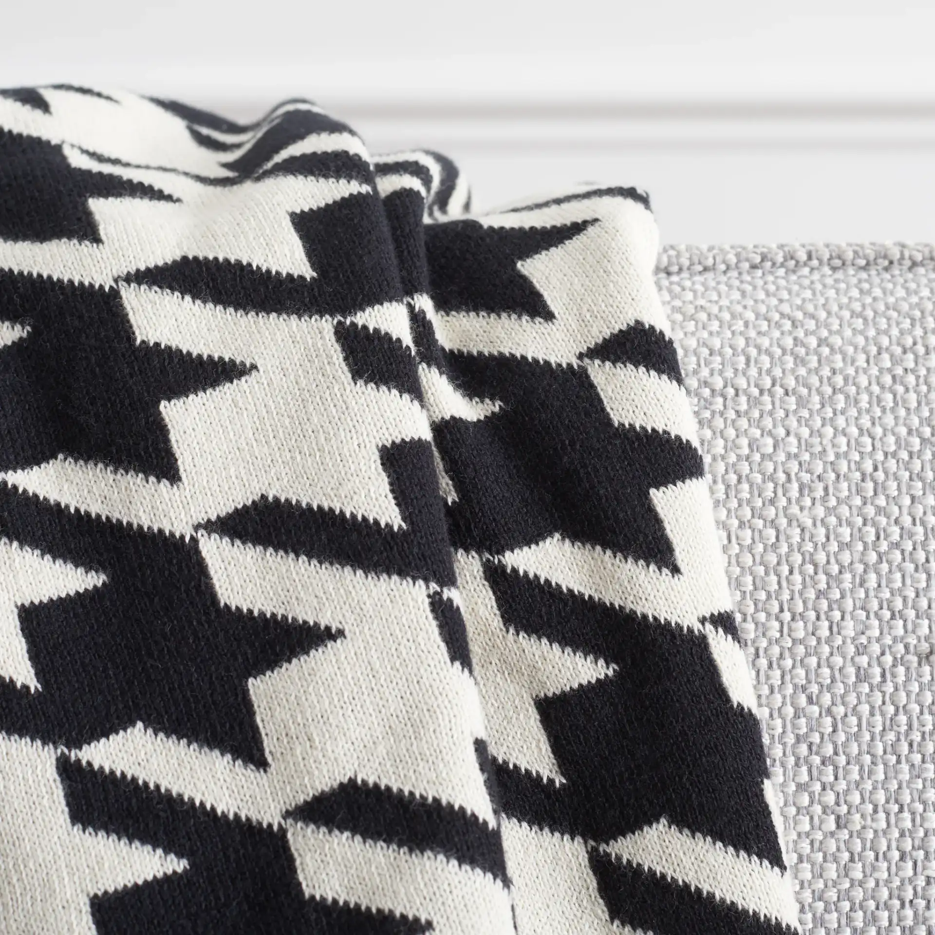 Cantil Throw in Black / Ivory in a styled room