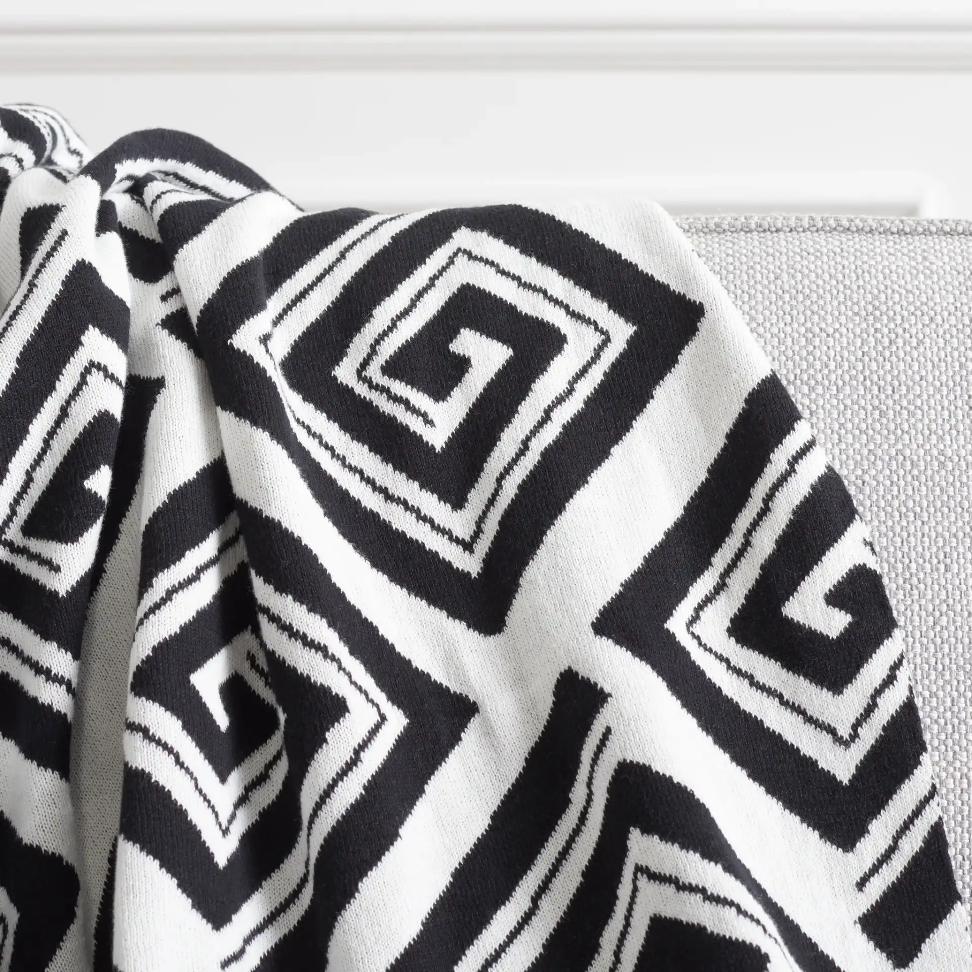 Veda Throw in Black / Ivory in a styled room