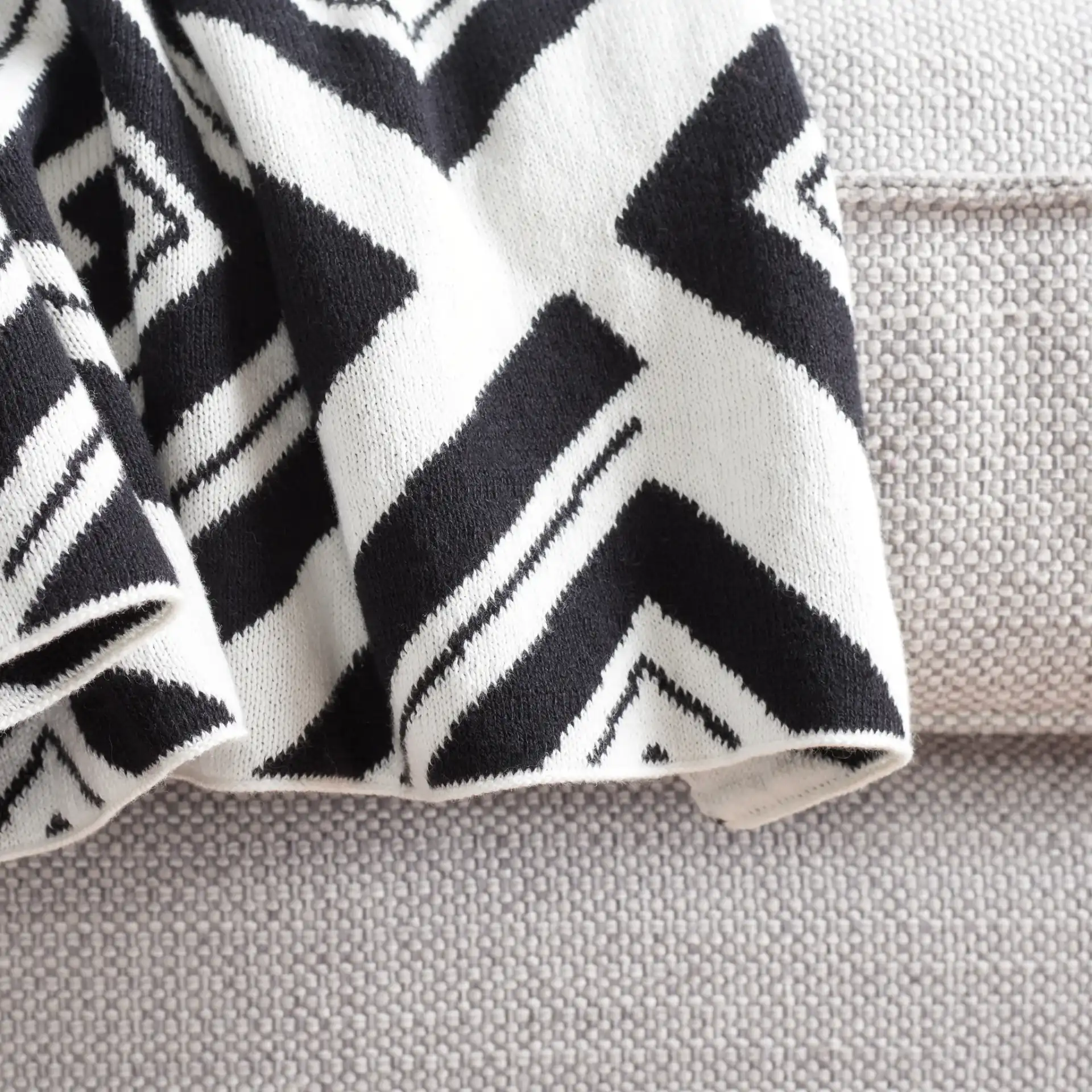 Veda Throw in Black / Ivory in a styled room