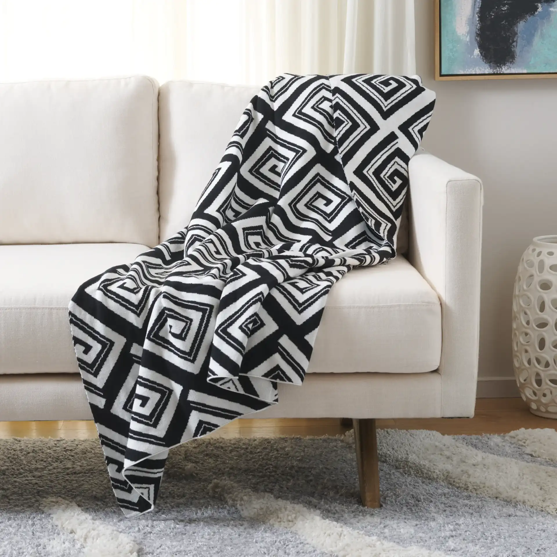 Veda Throw in Black / Ivory in a styled room