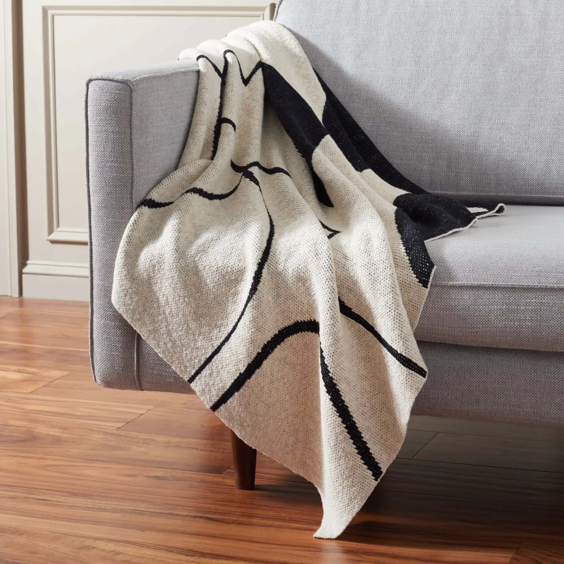 Cleon 50X60 Throw in Black / Ivory in a styled room