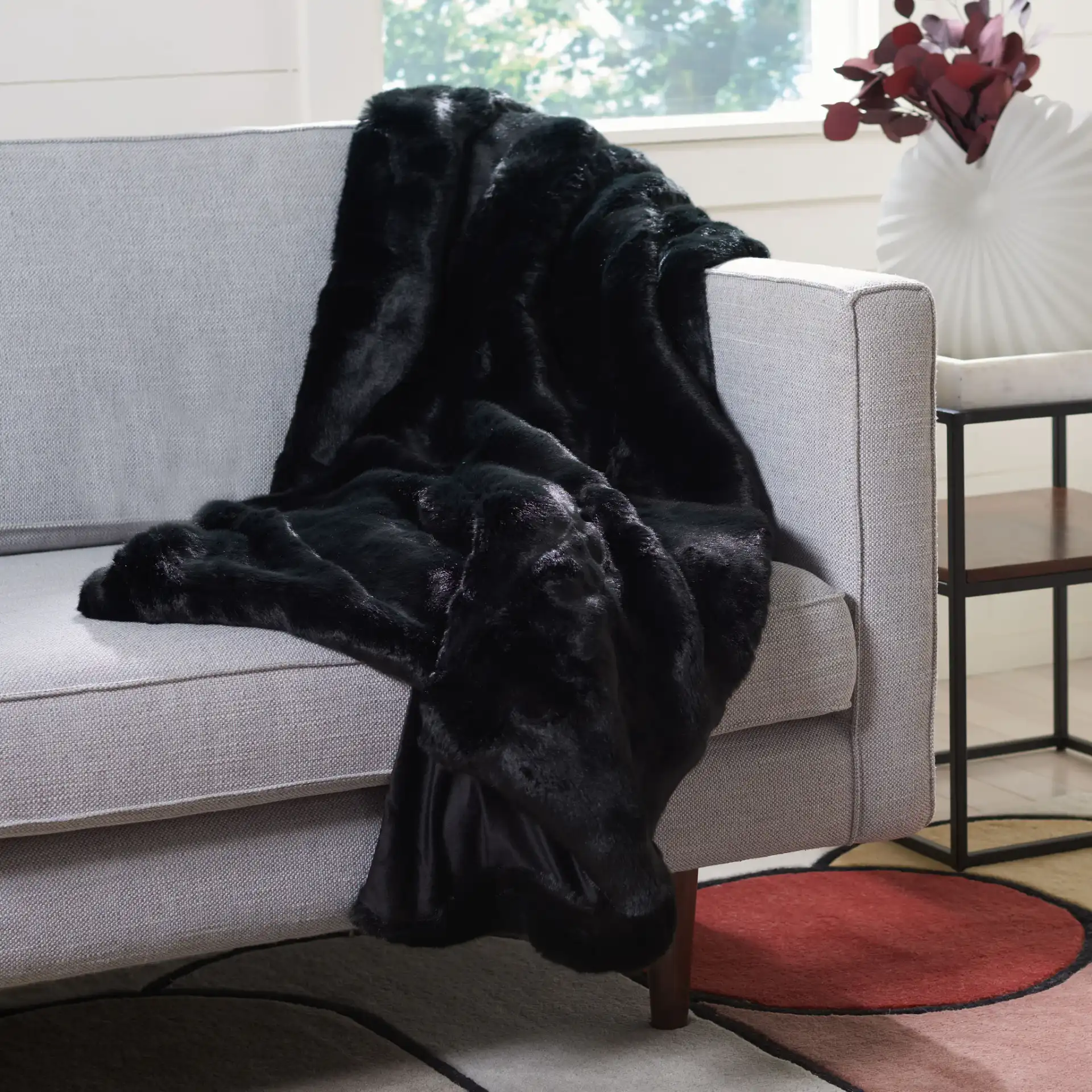 Faux Black Mink Throw in Black in a styled room