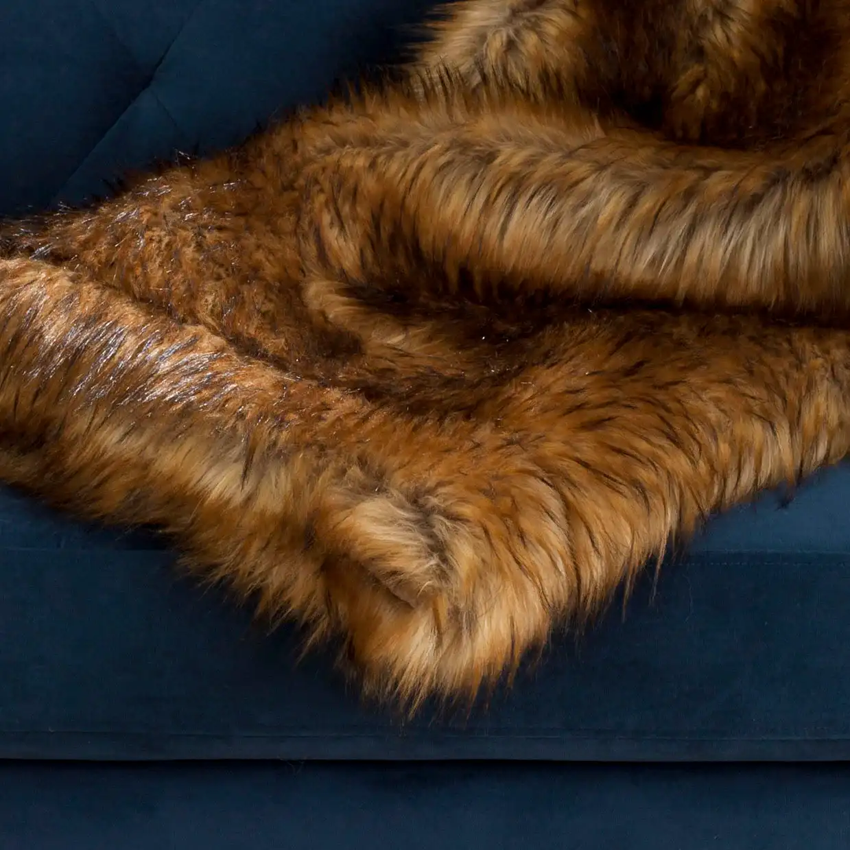Faux Raccoon Throw in Brown / Multicolor in a styled room