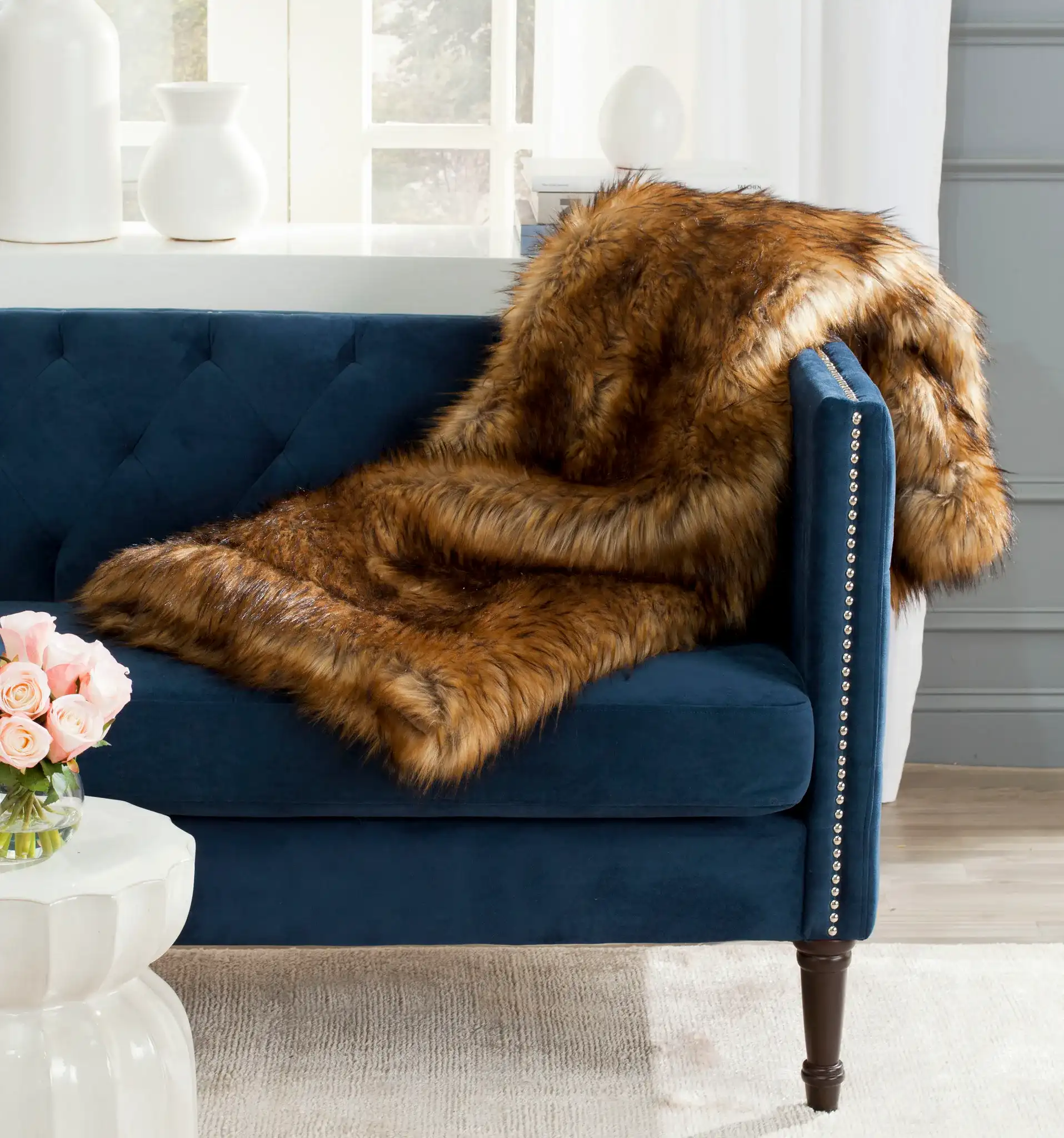 Faux Raccoon Throw in Brown / Multicolor in a styled room