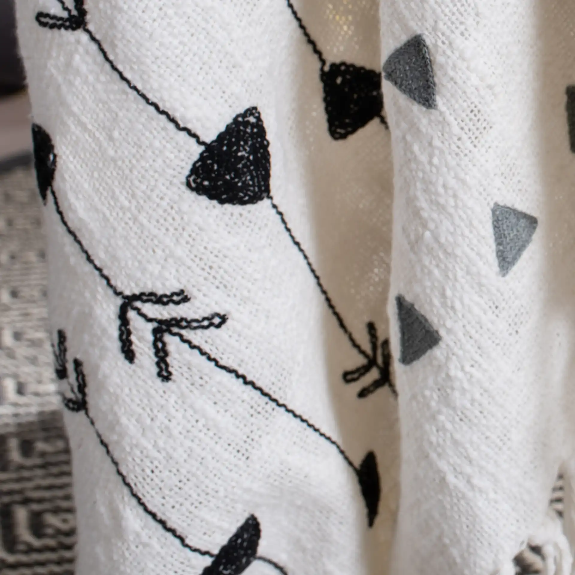 Penton Throw in Gray / White in a styled room