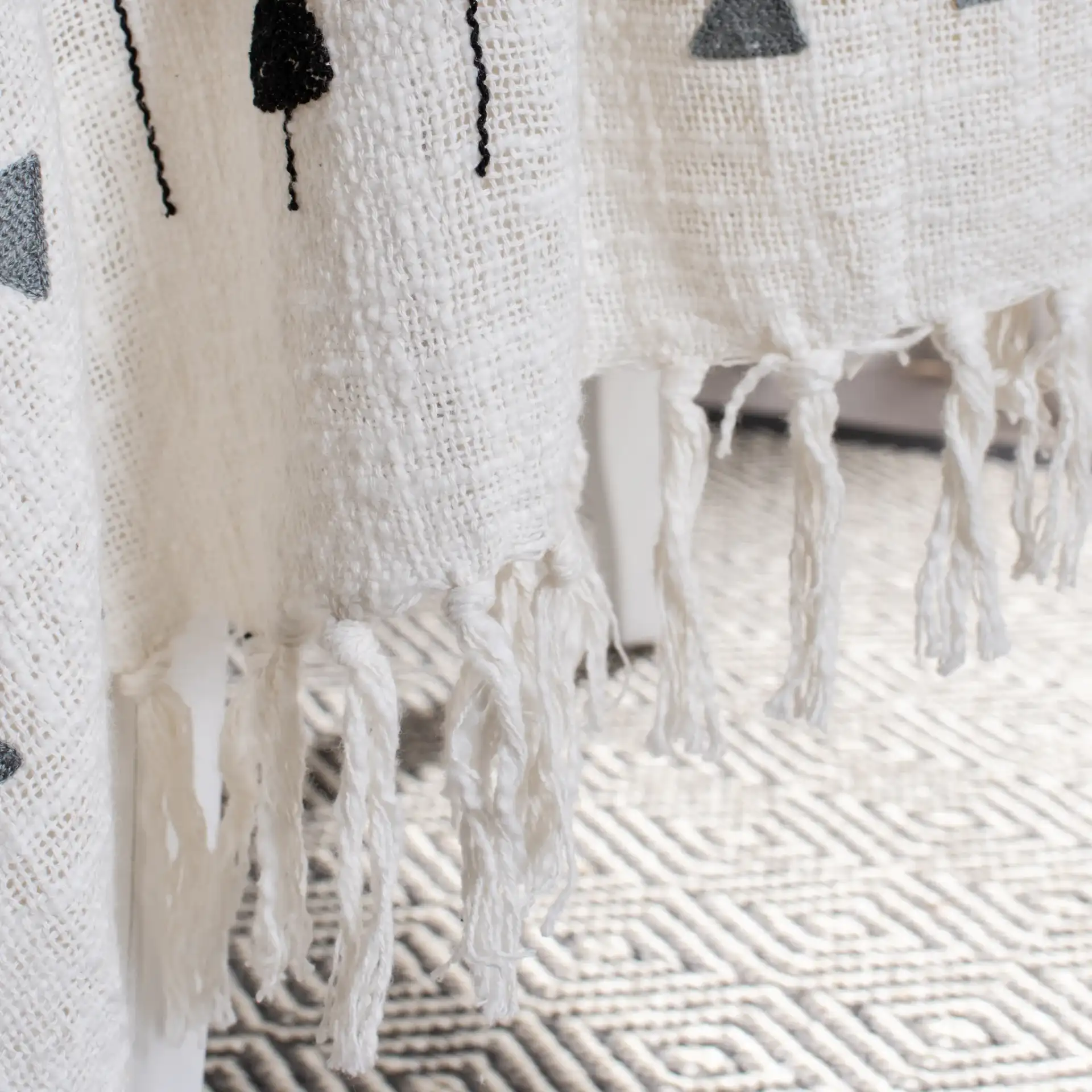 Penton Throw in Gray / White in a styled room