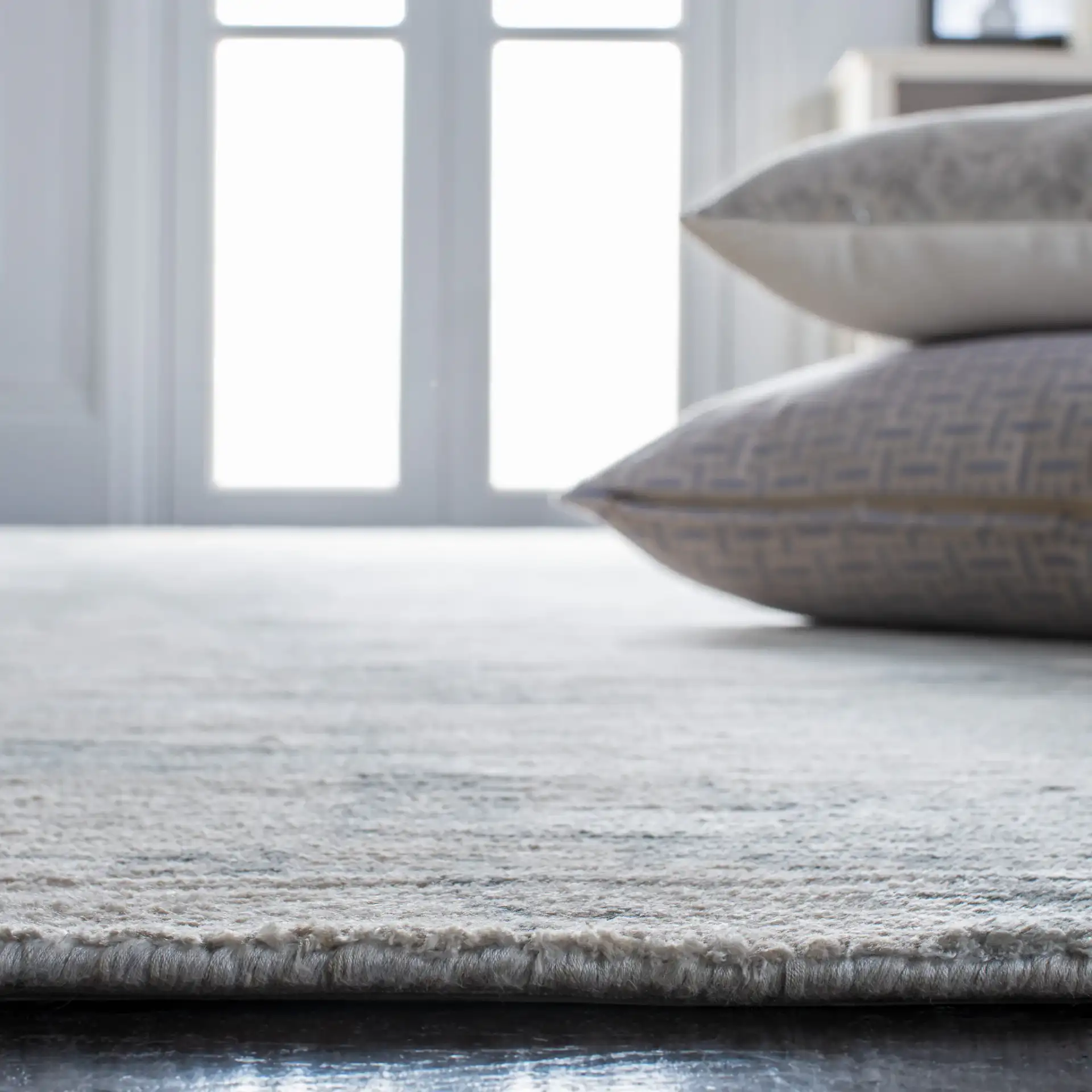 Tibetan Distressed Abstract Hand-Loomed Viscose Rug in Light Gray in a styled room