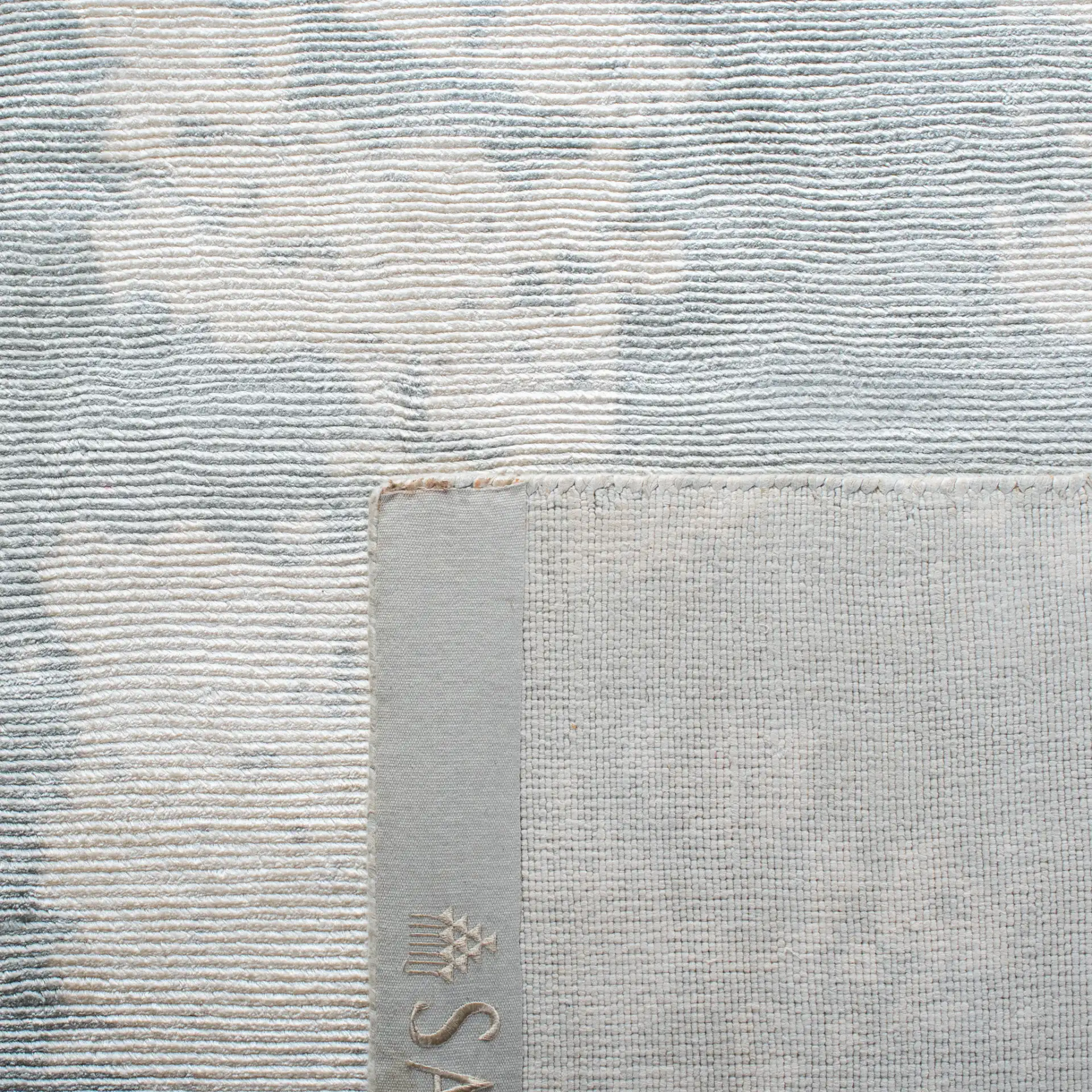 Tibetan Distressed Abstract Hand-Loomed Viscose Rug in Light Gray in a styled room