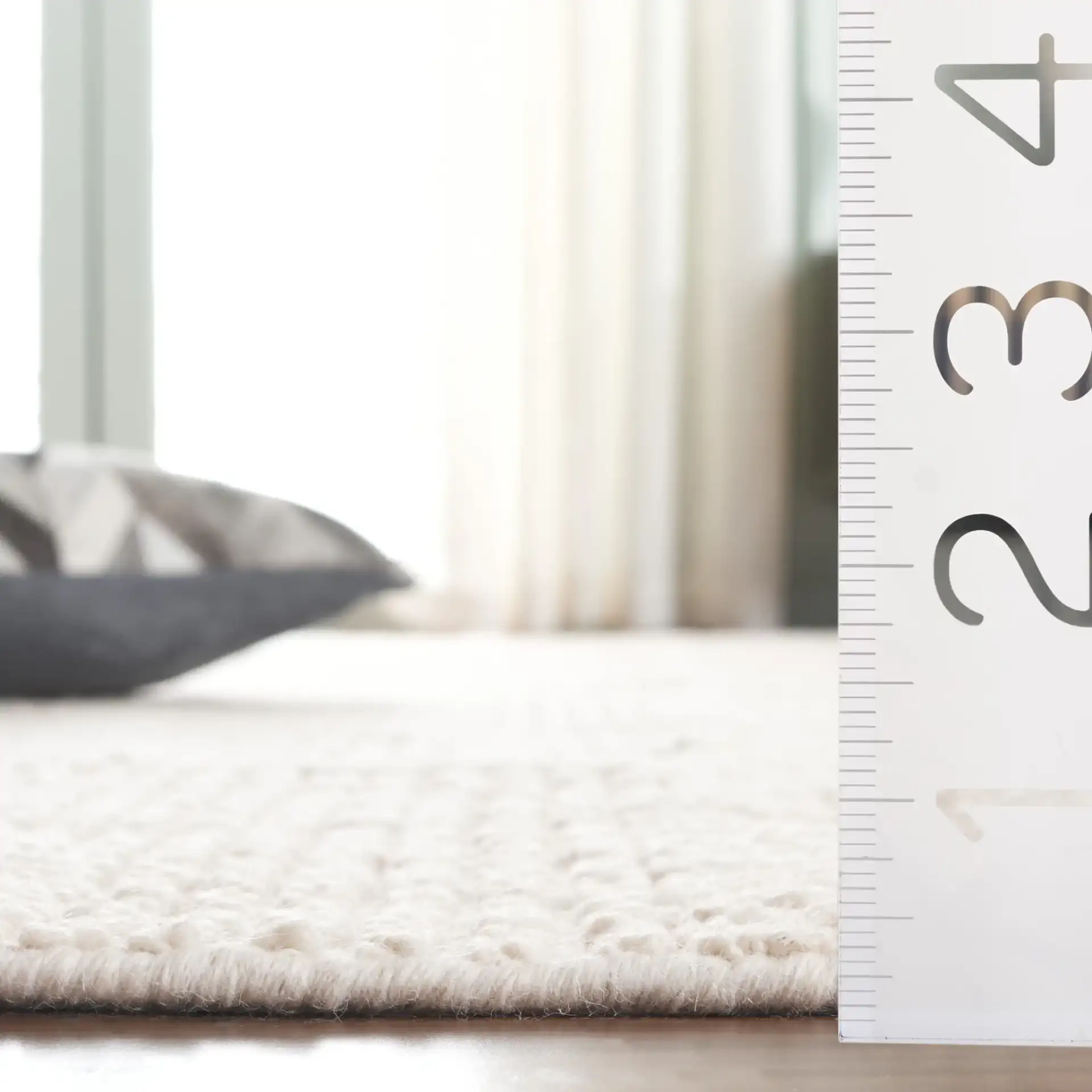 Tibetan Textured Grid Hand-Knotted Wool Rug in Ivory in a styled room
