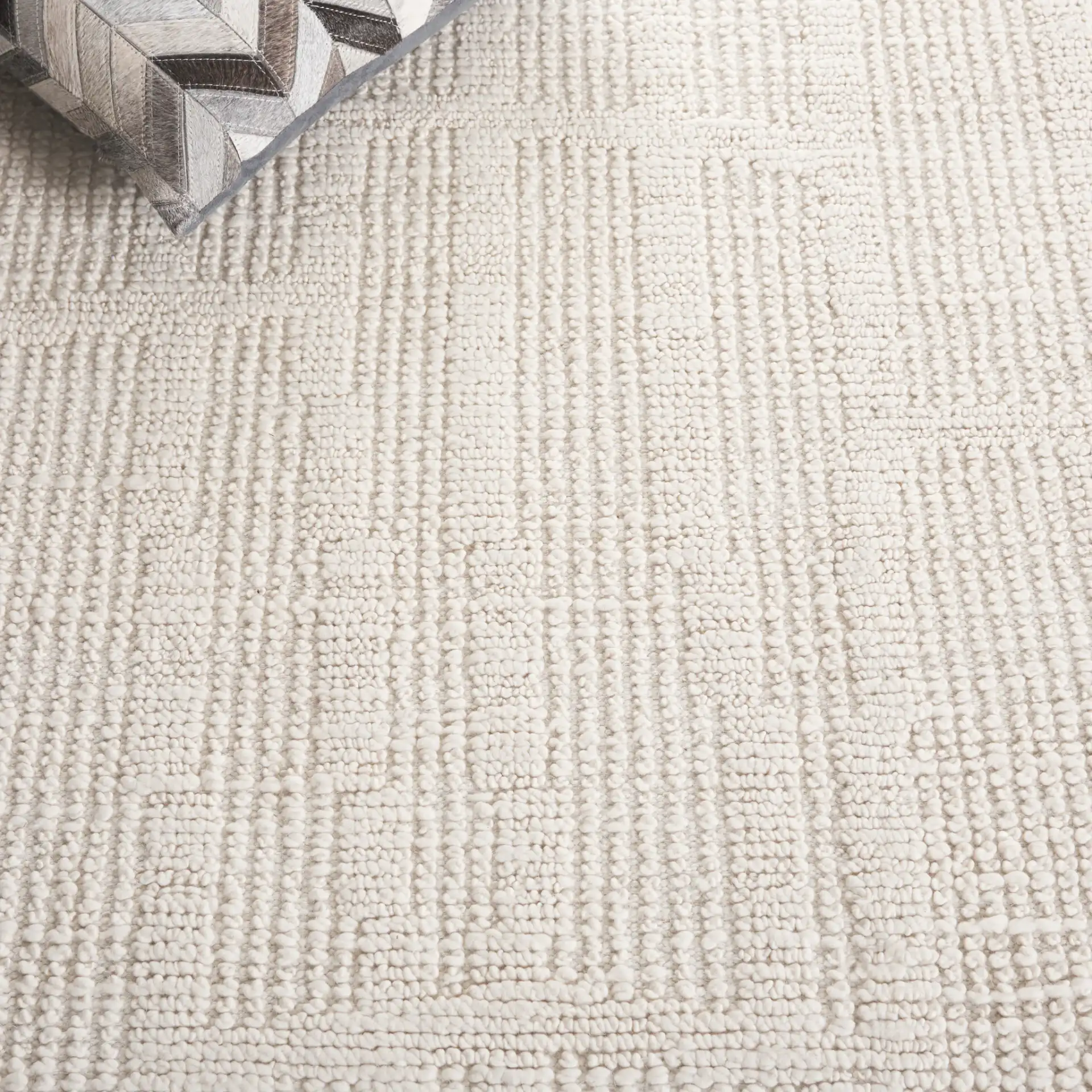 Tibetan Textured Grid Hand-Knotted Wool Rug in Ivory in a styled room