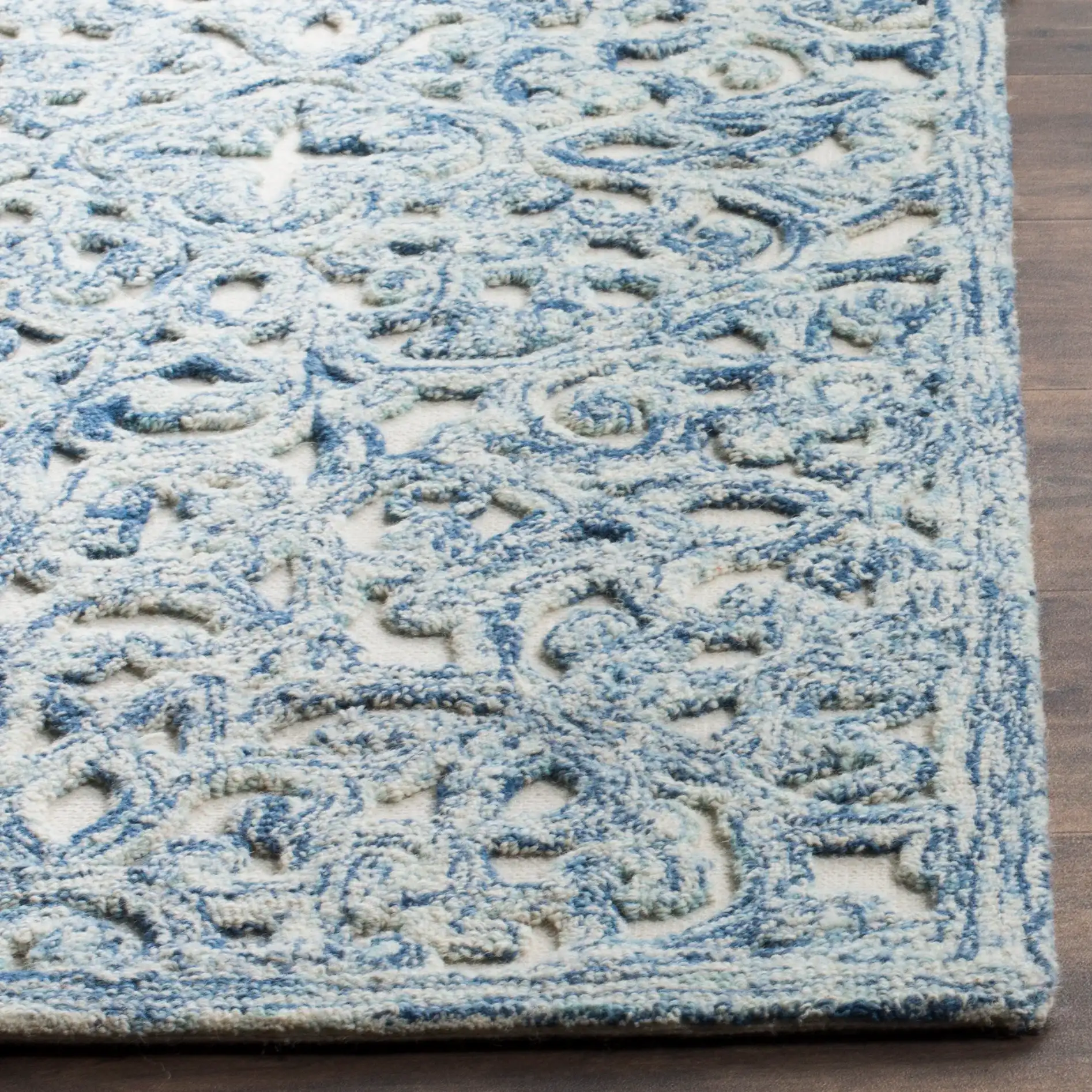 Trace Damask Scroll Hand-Tufted Wool Rug in Blue / Ivory in a styled room