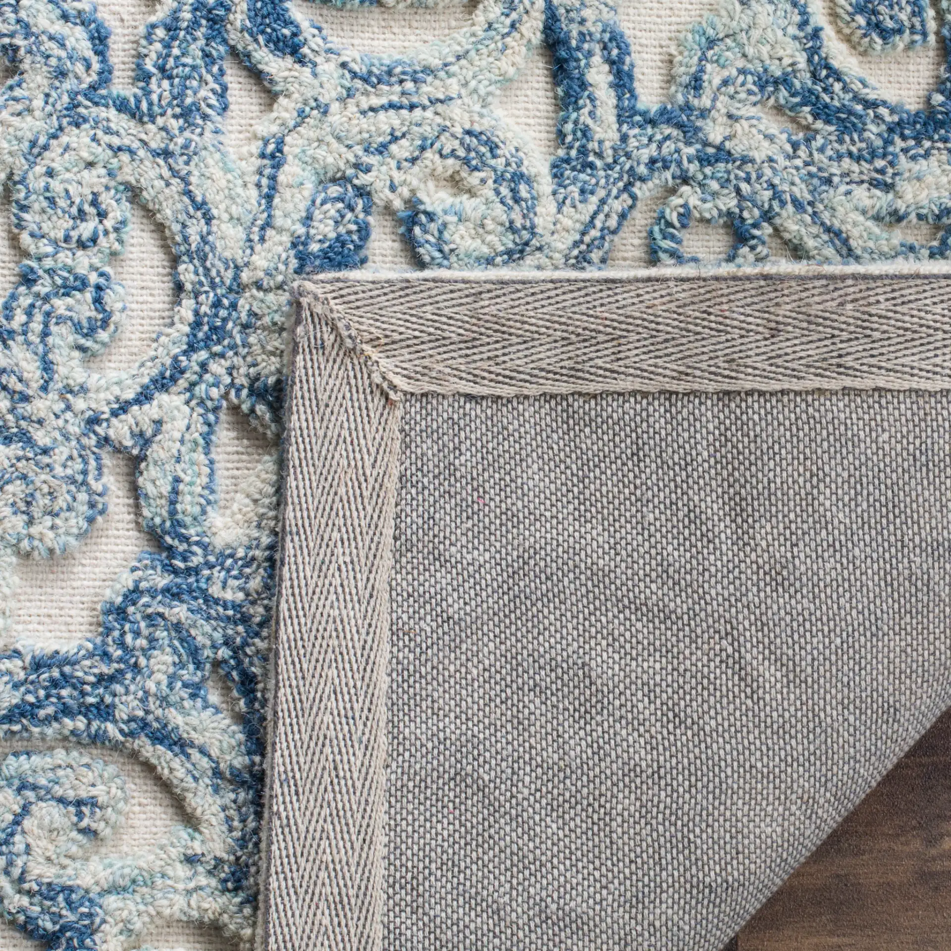 Trace Damask Scroll Hand-Tufted Wool Rug in Blue / Ivory in a styled room