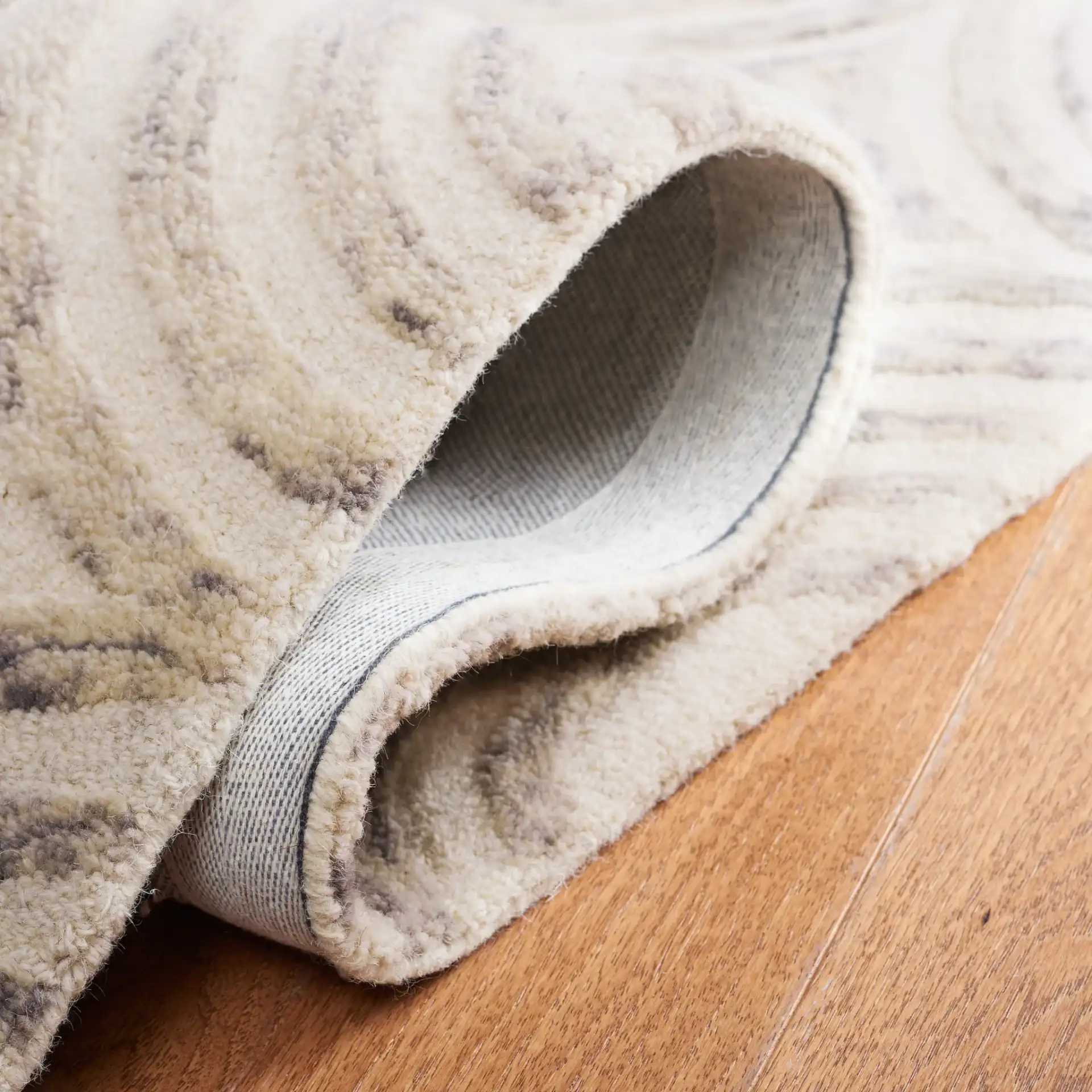 Trace Concentric Oval Hand-Tufted Wool Rug in Gray / Ivory in a styled room