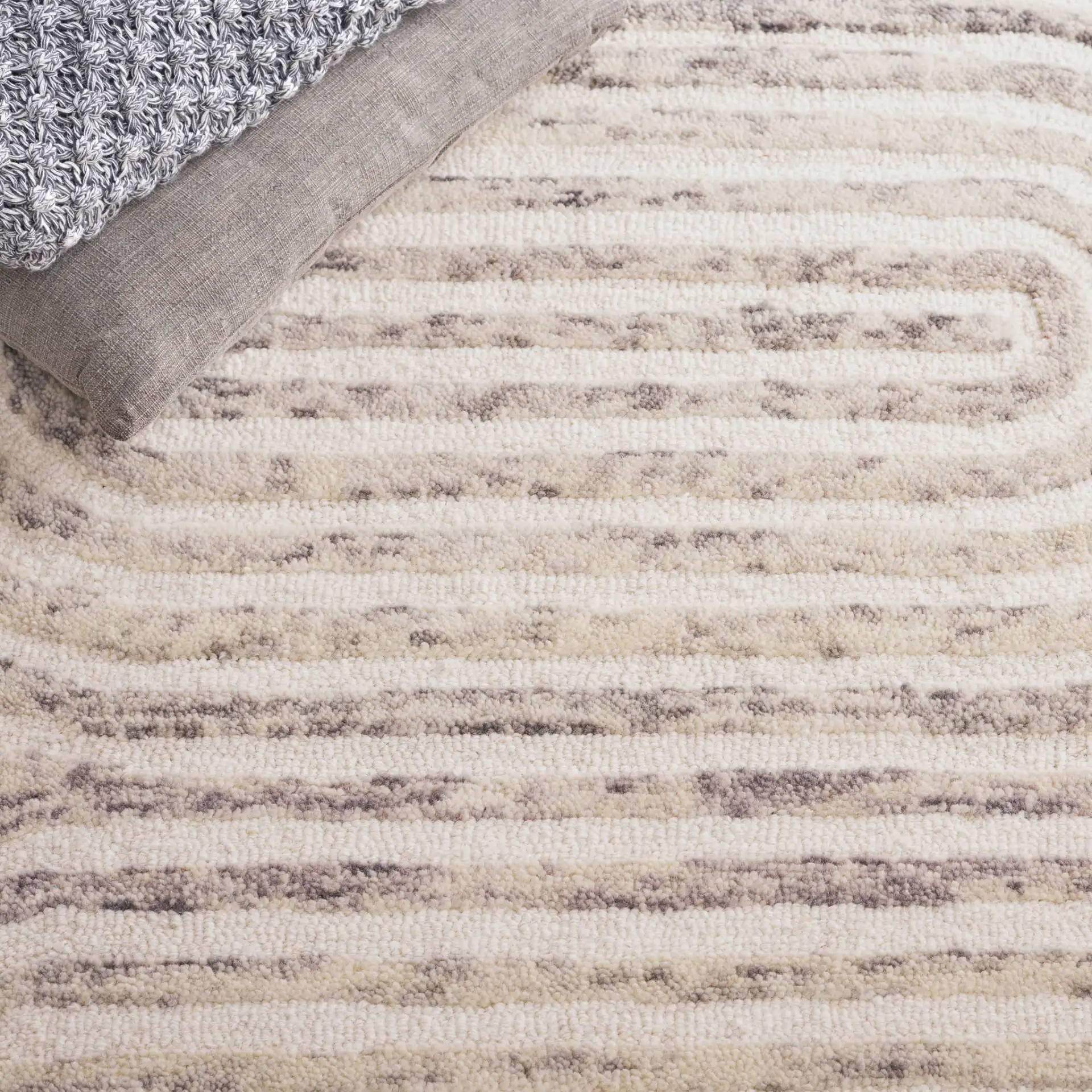 Trace Concentric Oval Hand-Tufted Wool Rug in Gray / Ivory in a styled room
