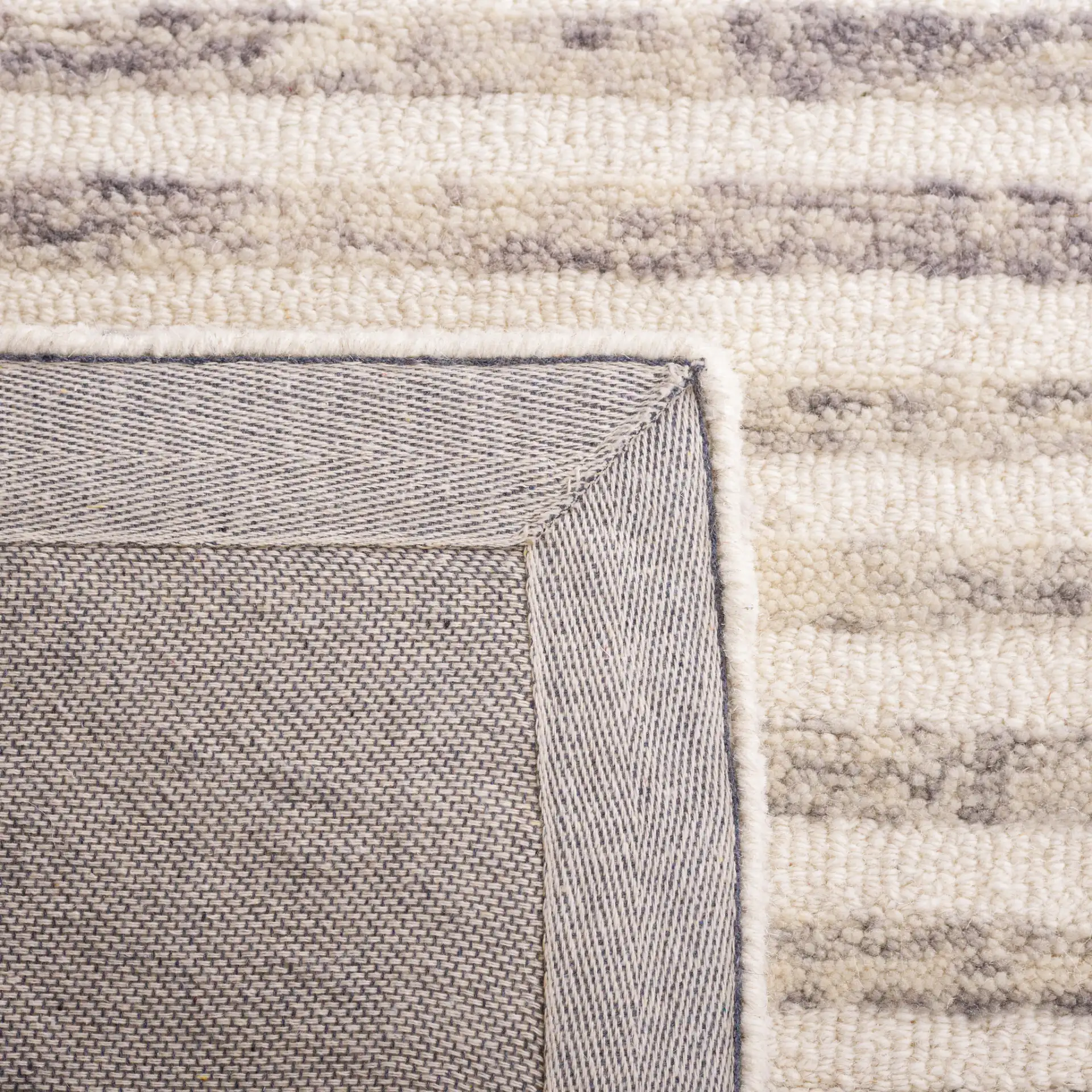 Trace Concentric Oval Hand-Tufted Wool Rug in Gray / Ivory in a styled room