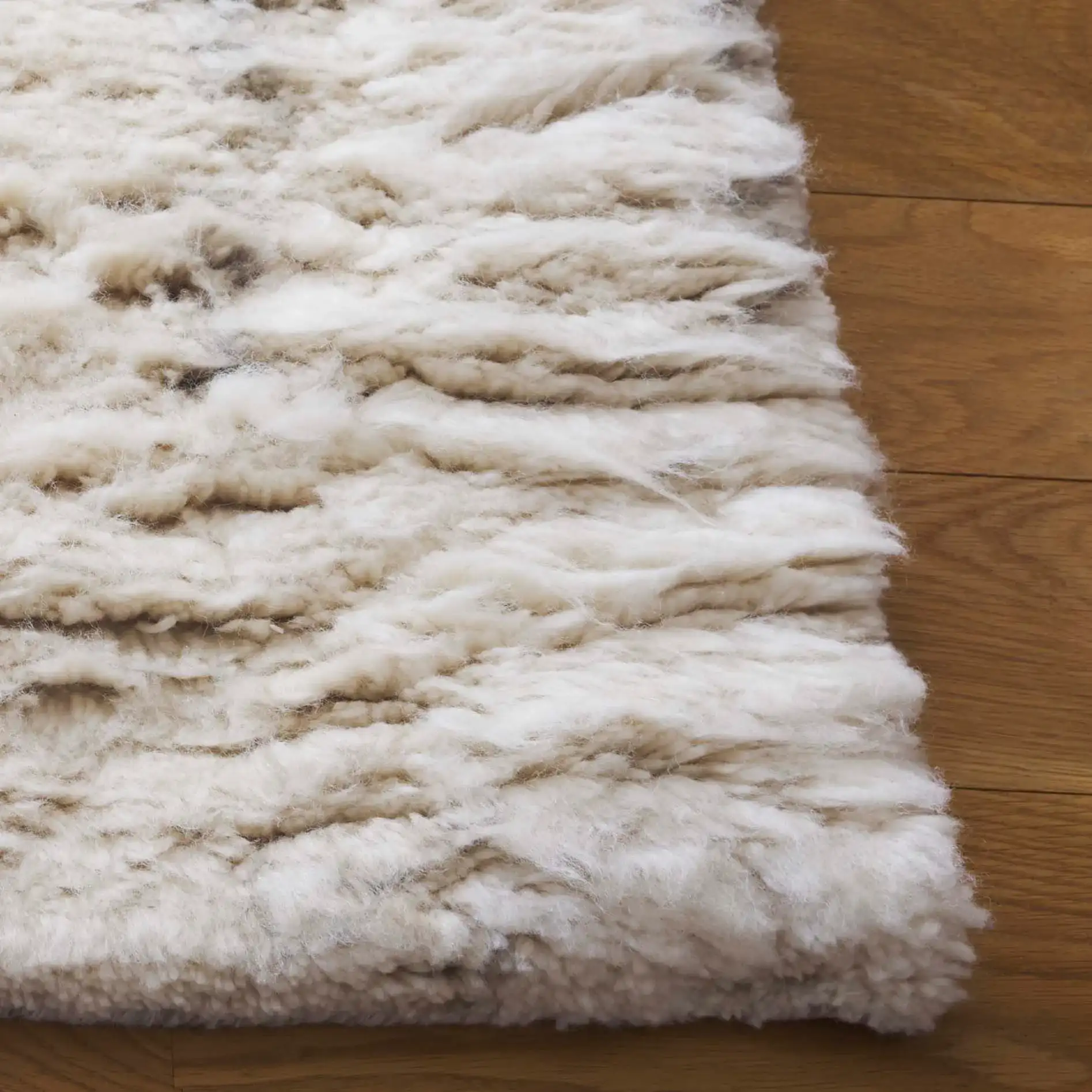 Tribeca Striated Hand-Knotted Shag Wool Rug in Gray / Beige in a styled room