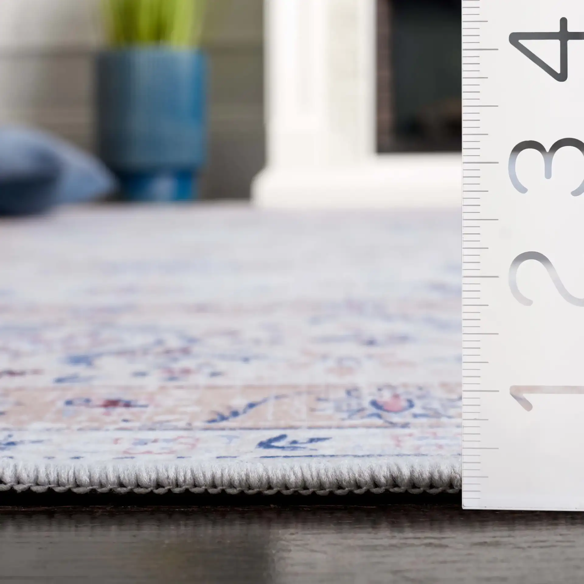 Tucson Distressed Floral Border Washable Rug in Ivory / Blue in a styled room