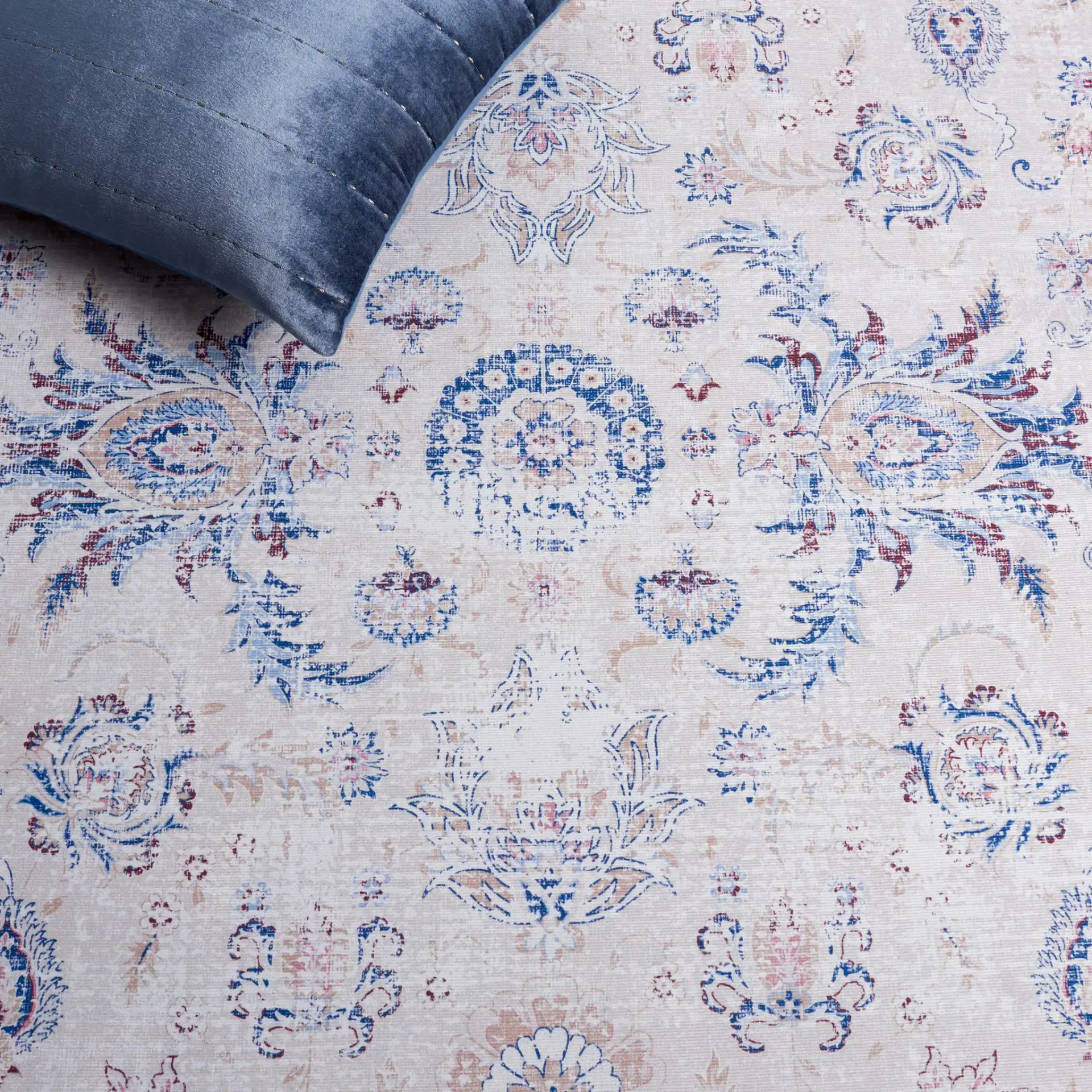 Tucson Distressed Floral Border Washable Rug in Ivory / Blue in a styled room