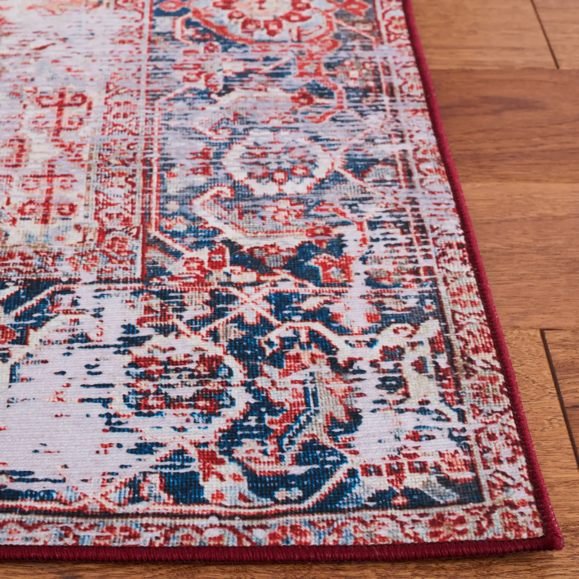 Tucson Distressed Hexagon Medallion Washable Rug in Rust / Navy in a styled room