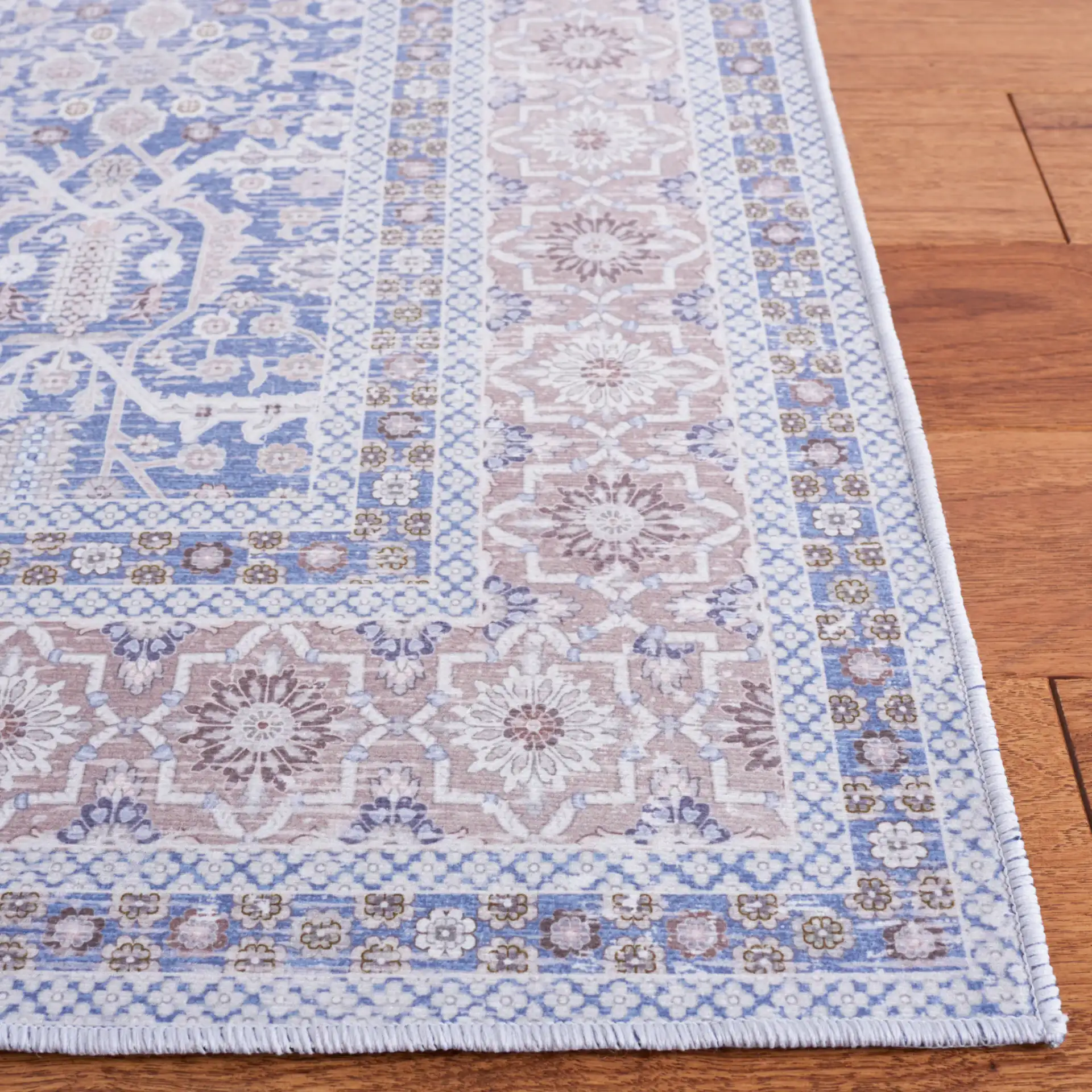 Tucson Allover Floral Washable Rug in Blue / Rust in a styled room