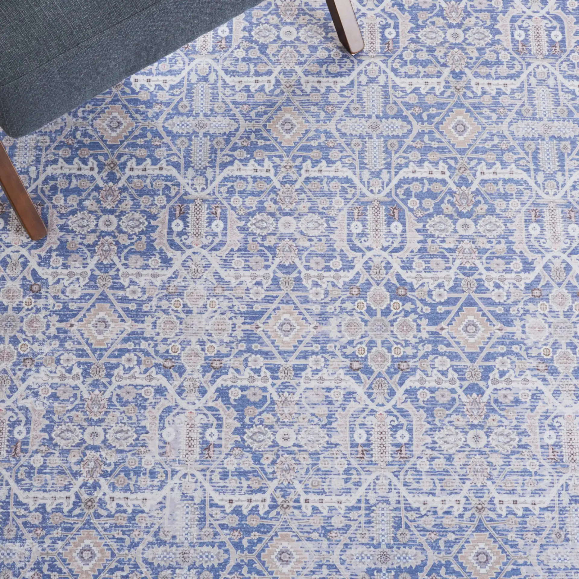 Tucson Allover Floral Washable Rug in Blue / Rust in a styled room