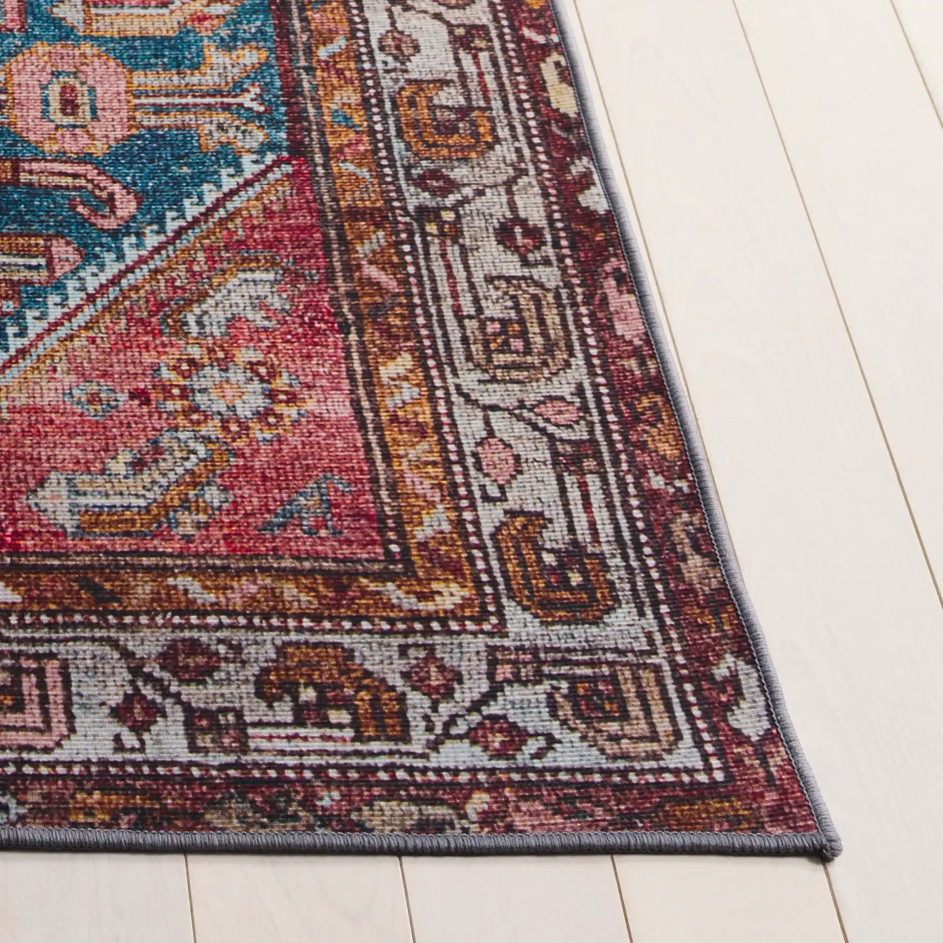 Tucson Tribal Pointed Diamond Medallion Washable Rug in Blue / Rust in a styled room
