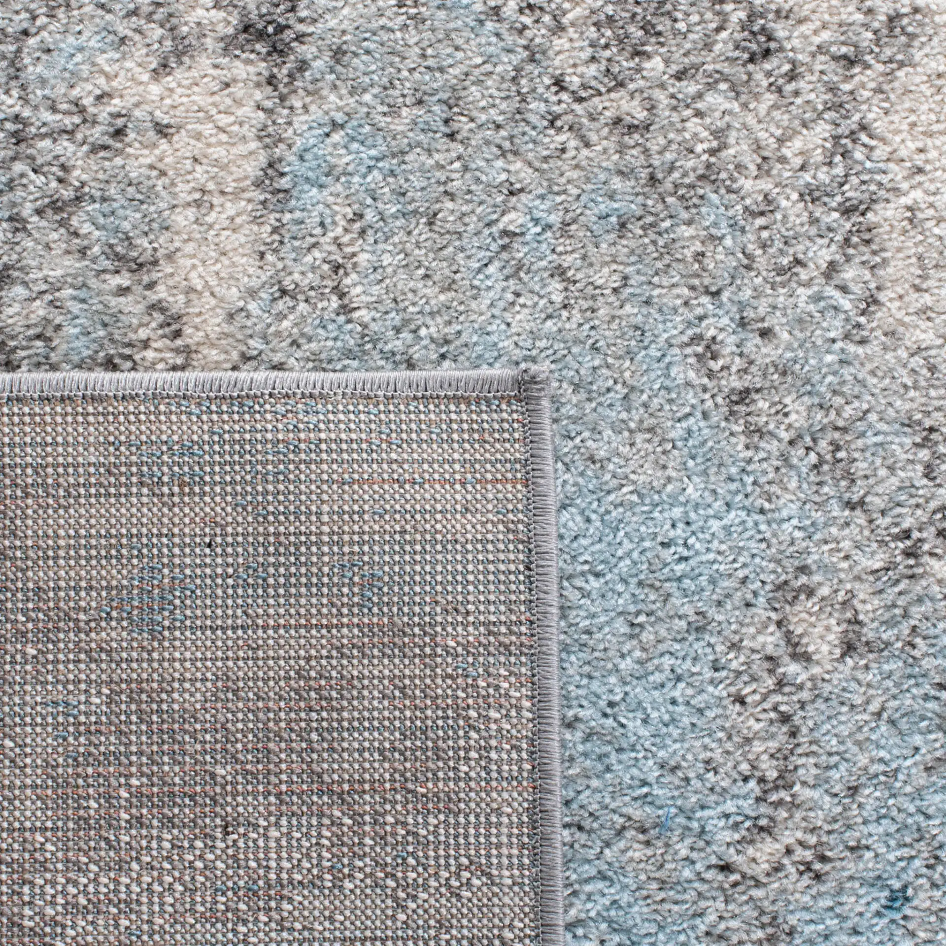 Tulum Abstract Rug in Gray / Blue in a styled room