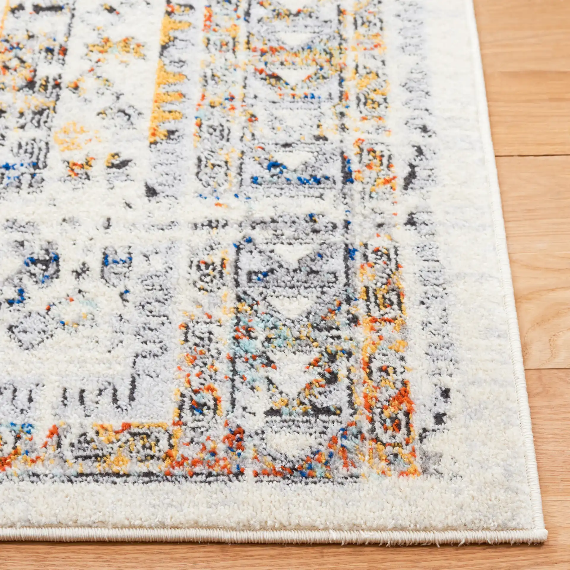 Tulum Geometric Panel Rug in Ivory Gray / Blue Rust in a styled room