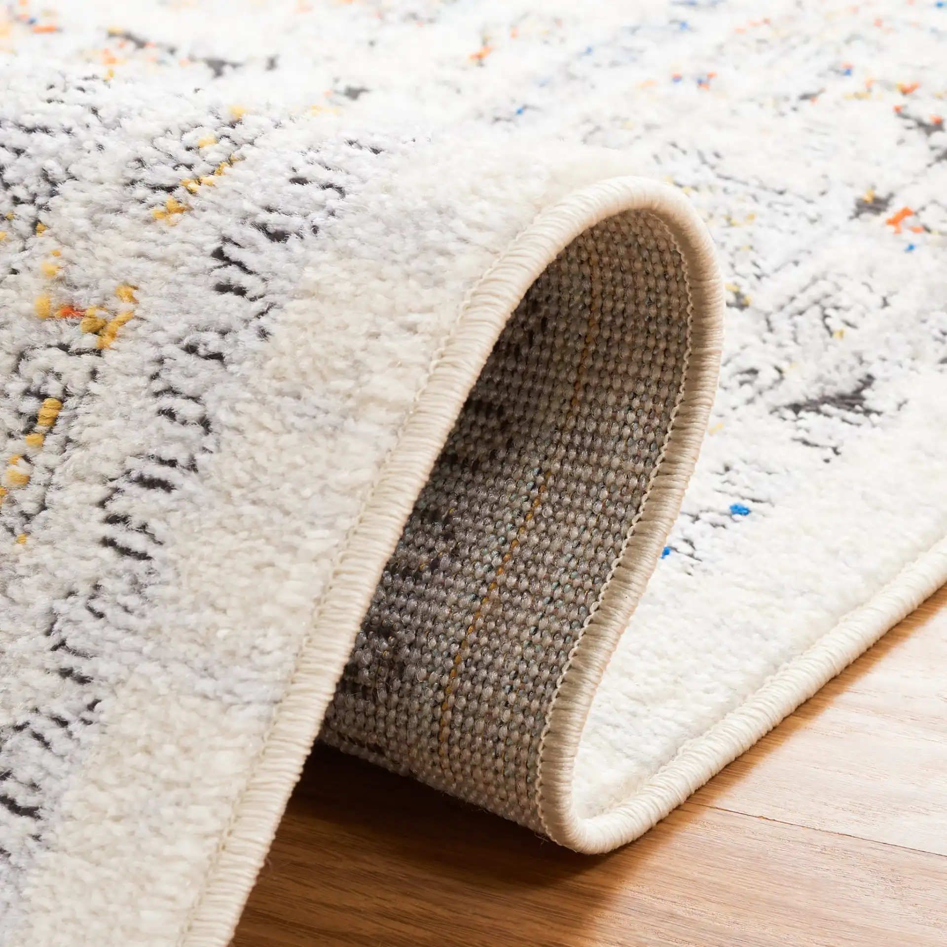 Tulum Geometric Panel Rug in Ivory Gray / Blue Rust in a styled room