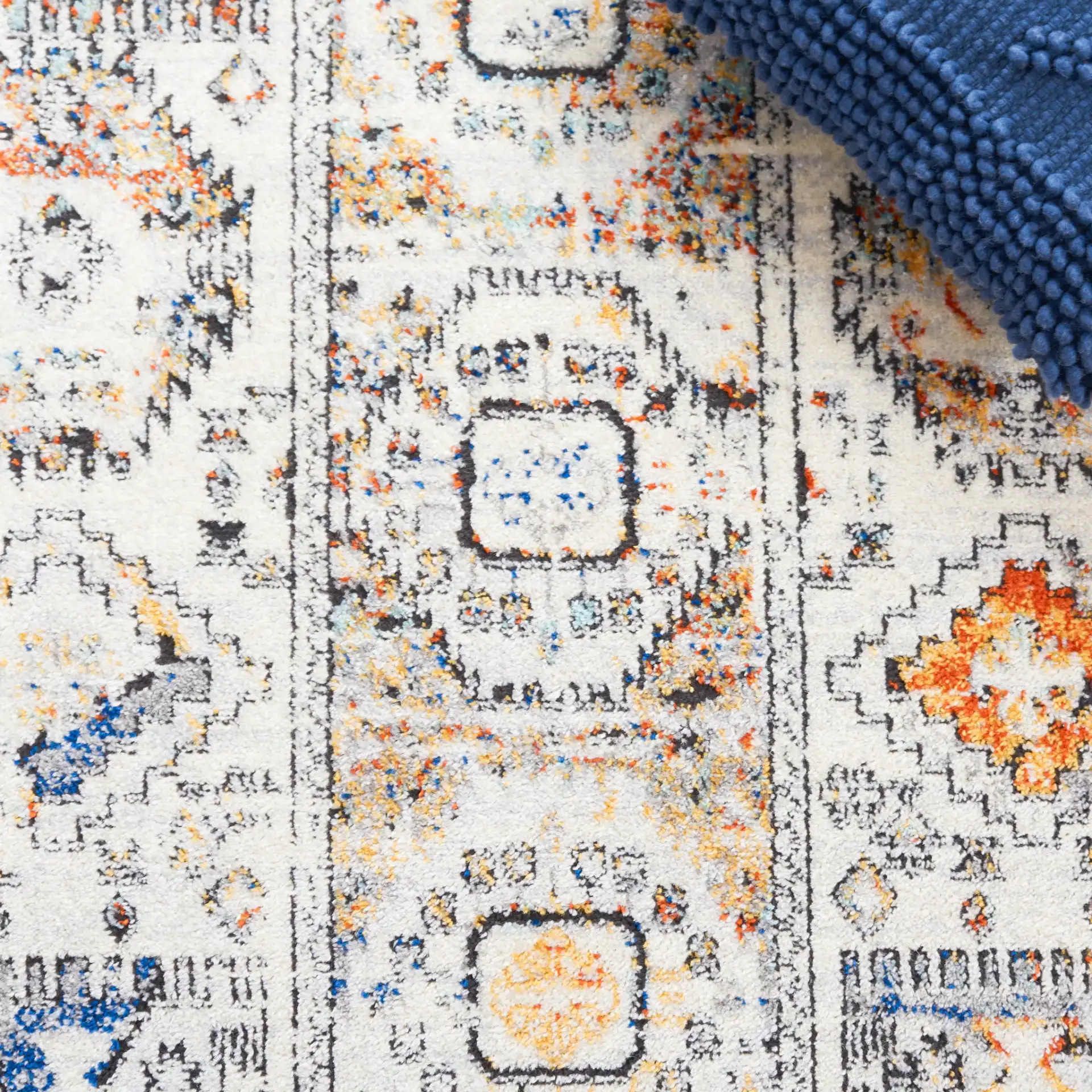 Tulum Geometric Panel Rug in Ivory Gray / Blue Rust in a styled room