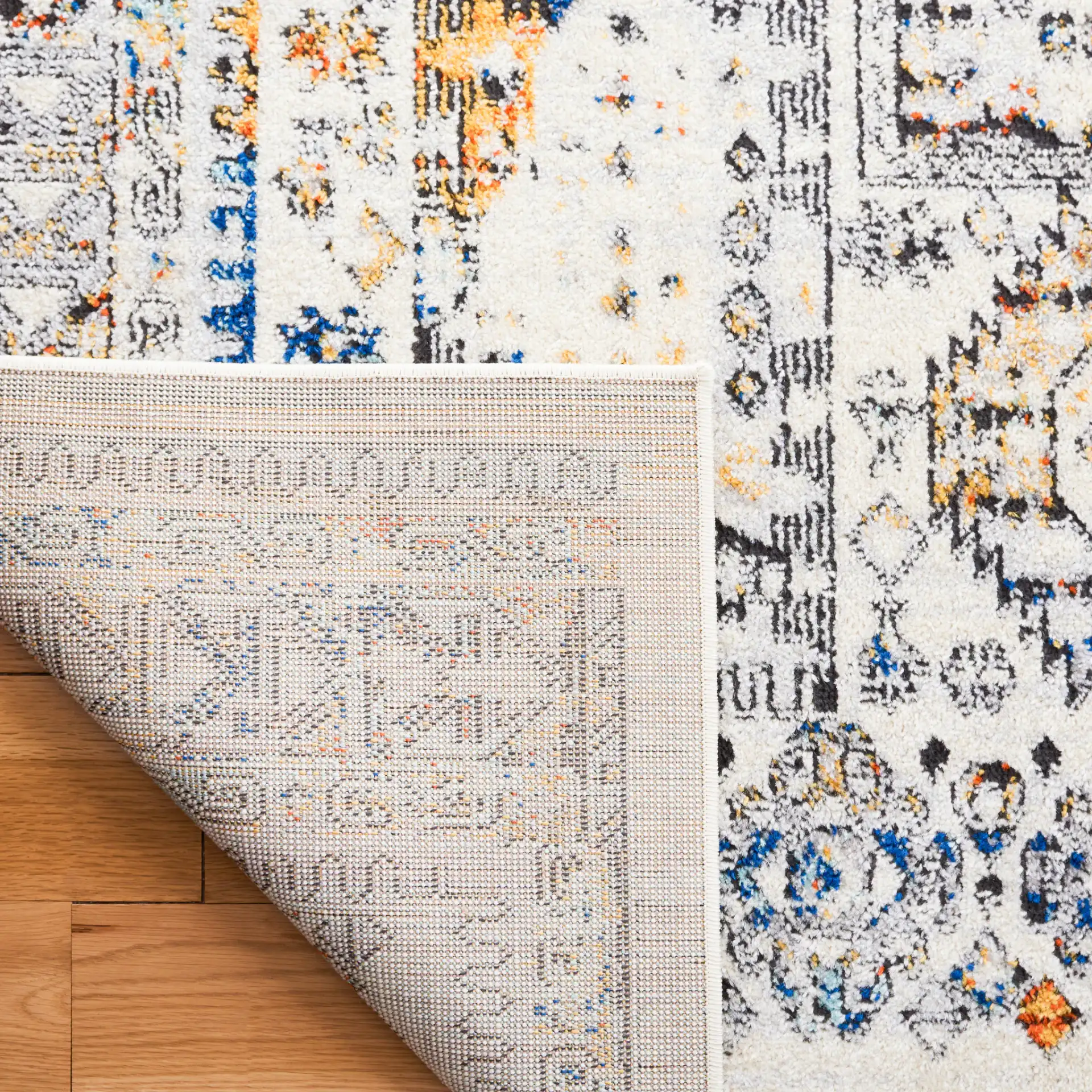 Tulum Geometric Panel Rug in Ivory Gray / Blue Rust in a styled room