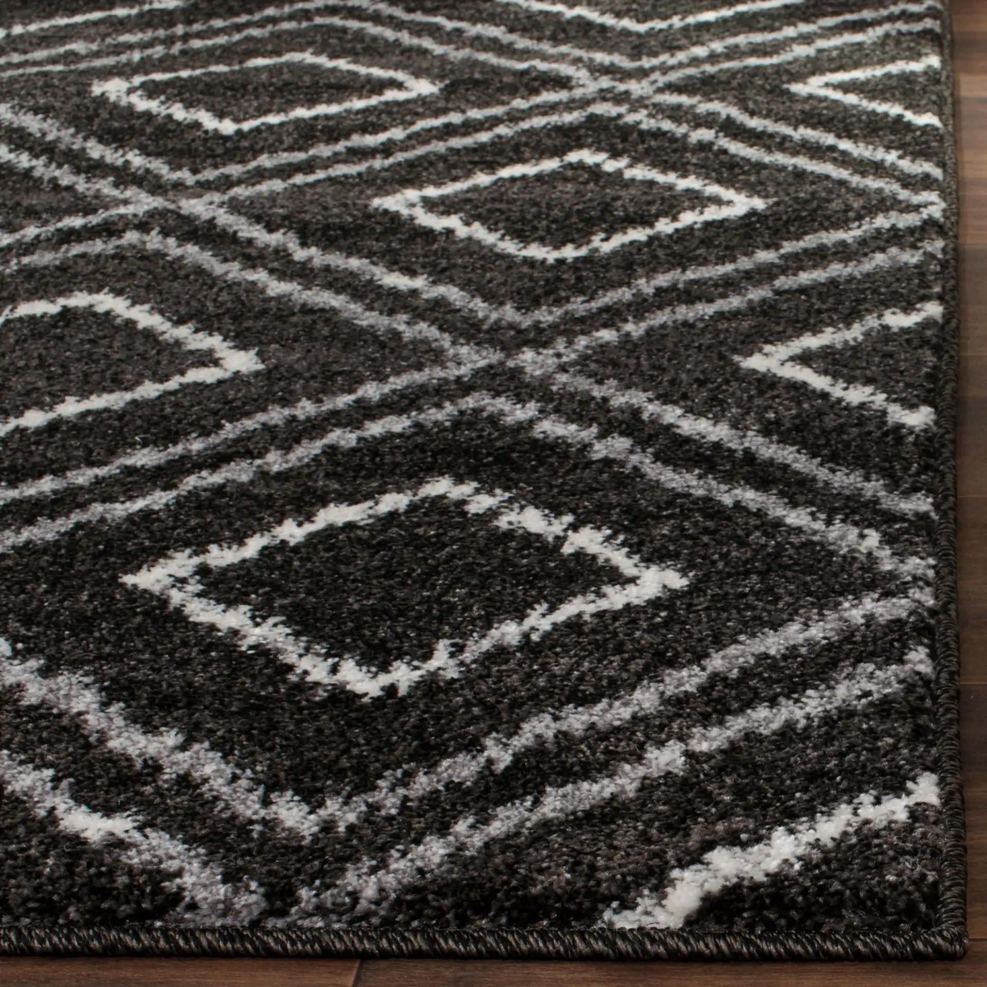 Tunisia Ikat Diamond Rug in Anthracite / Cream in a styled room