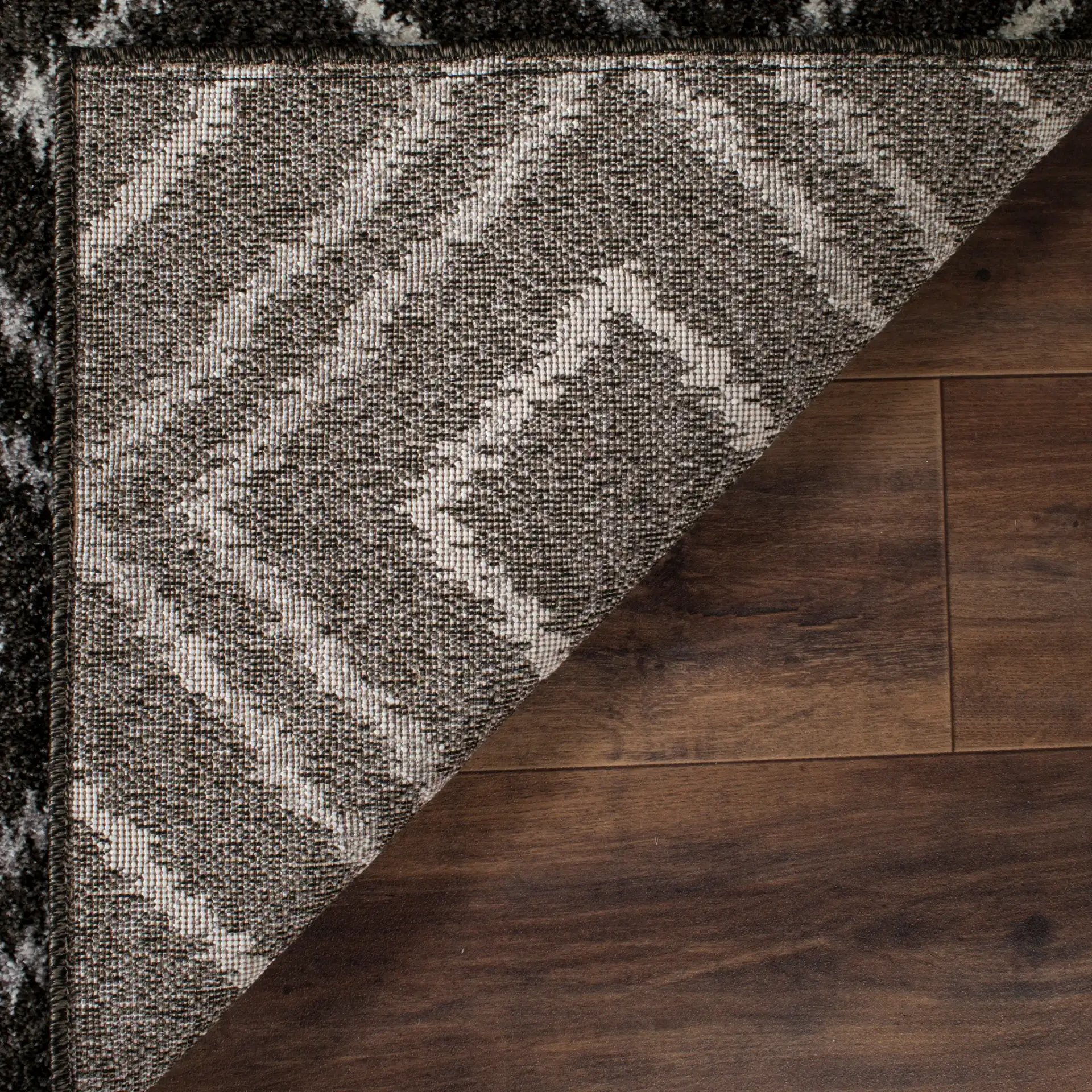 Tunisia Ikat Diamond Rug in Anthracite / Cream in a styled room