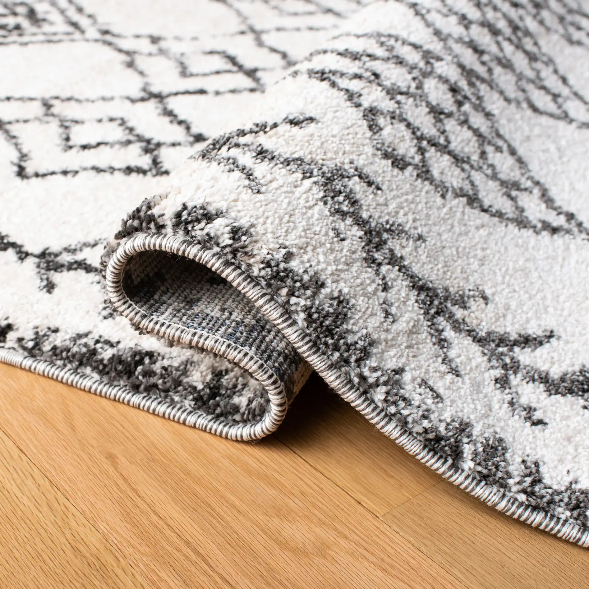 Tunisia Moroccan Diamond Trellis Rug in Ivory / Black in a styled room