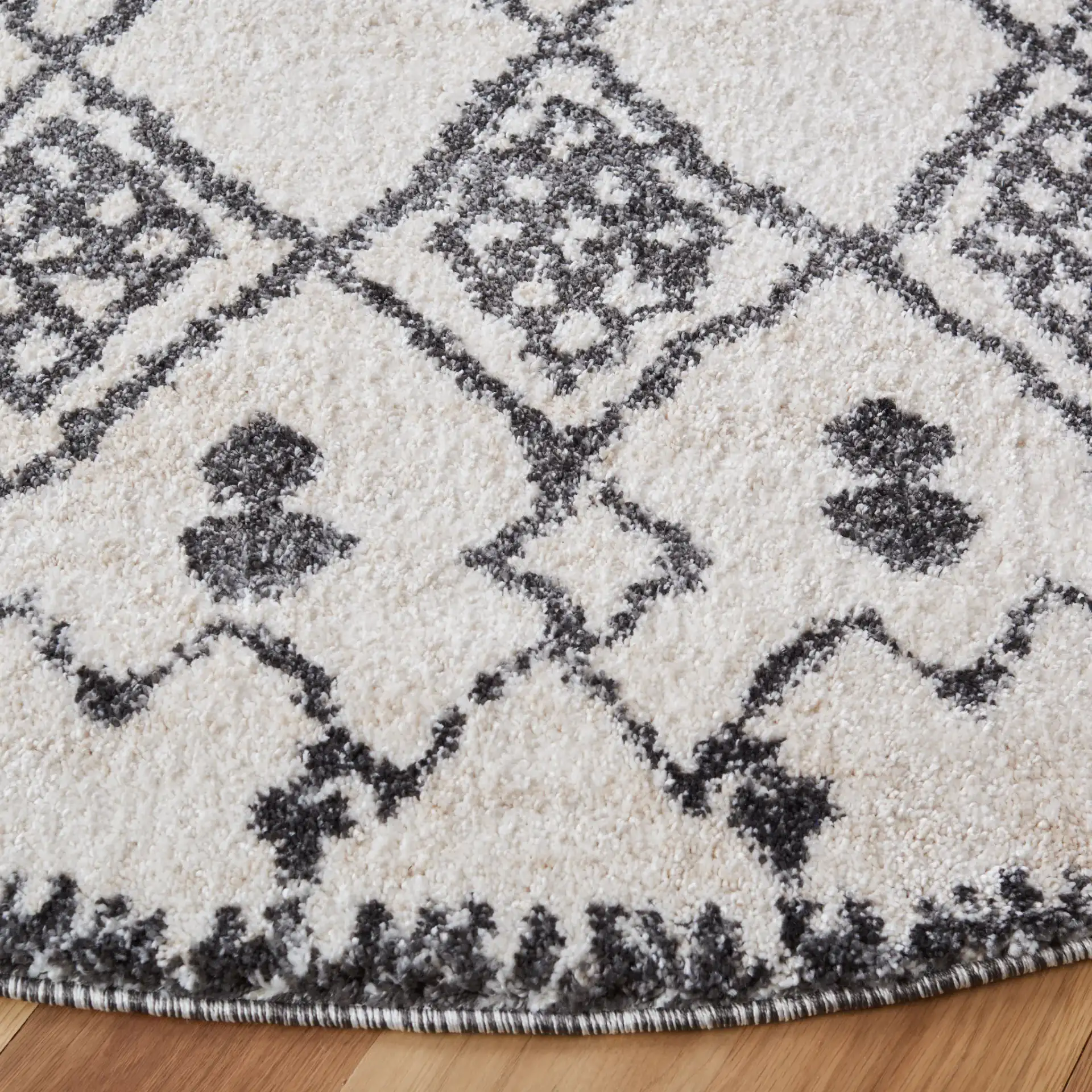 Tunisia Moroccan Diamond Trellis Rug in Ivory / Black in a styled room