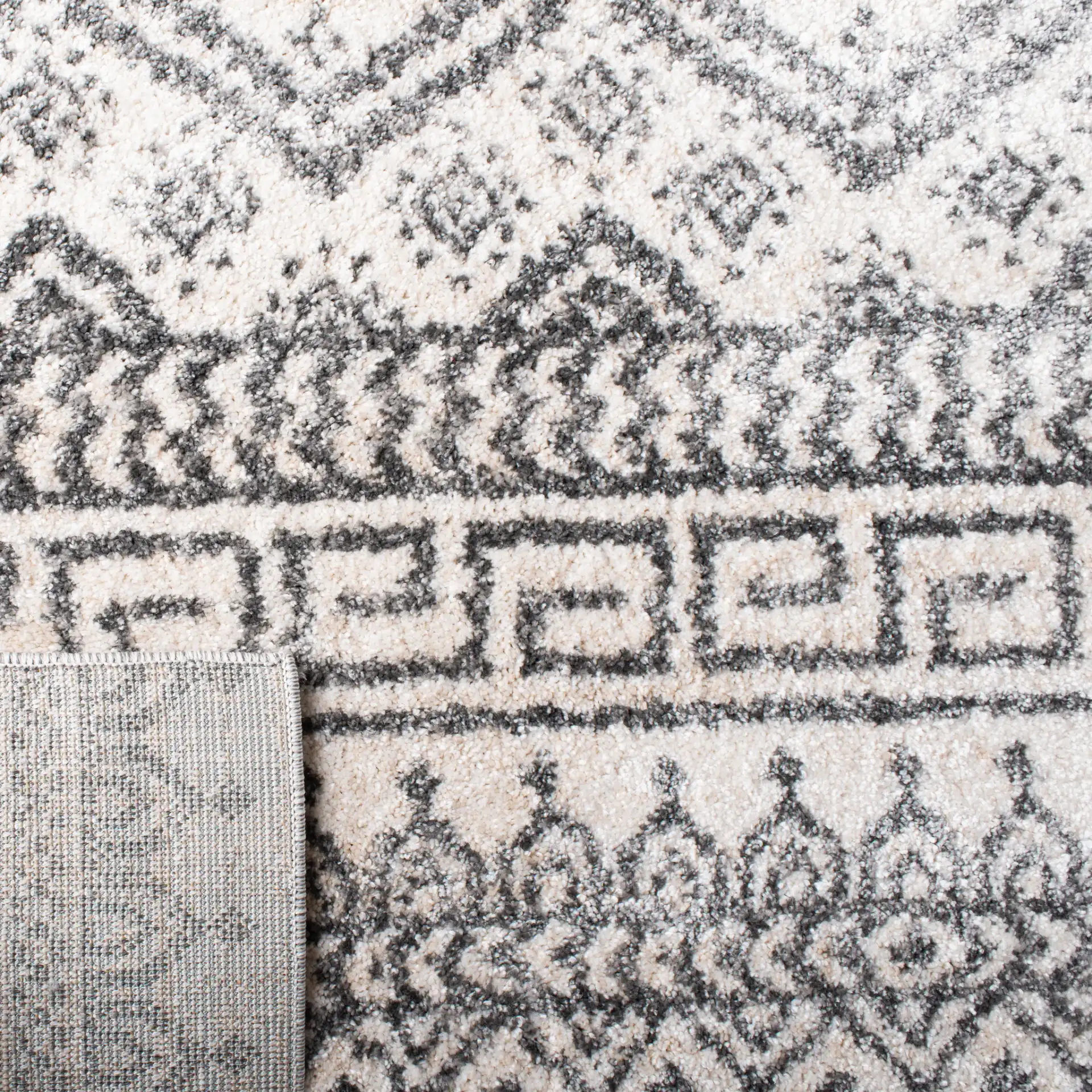 Tunisia Banded Diamond Rug in Ivory / Black in a styled room