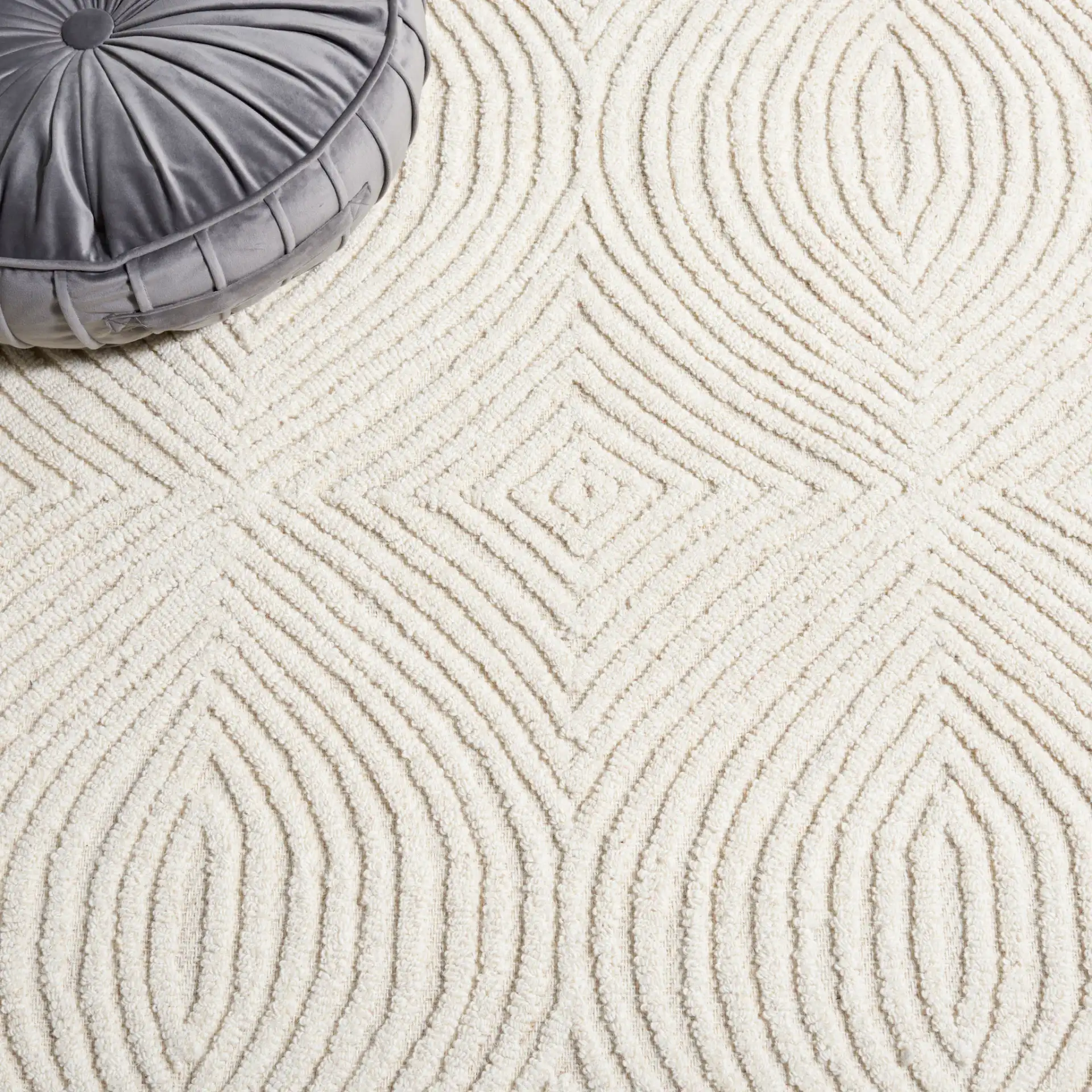 Textural Modern Concentric Diamond Hand-Tufted Wool Rug in Ivory in a styled room