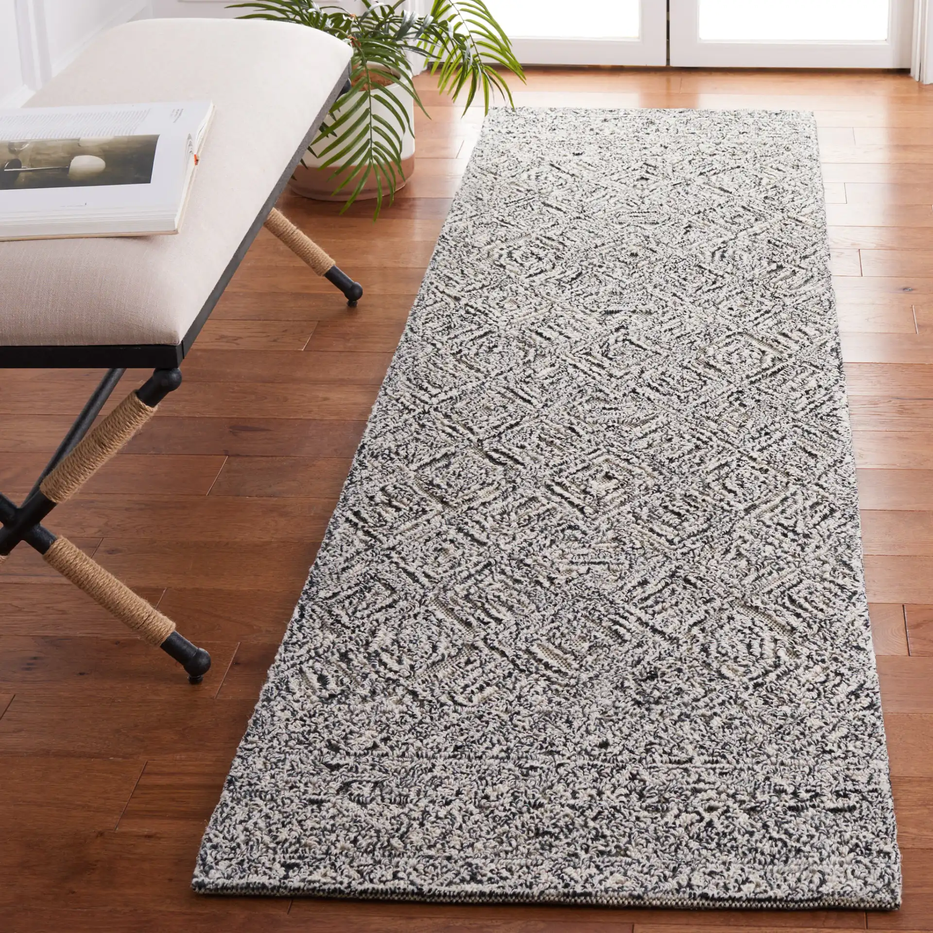 Textural Textual Nested Diamond Hand-Tufted Wool Rug in Black / Ivory in a styled room