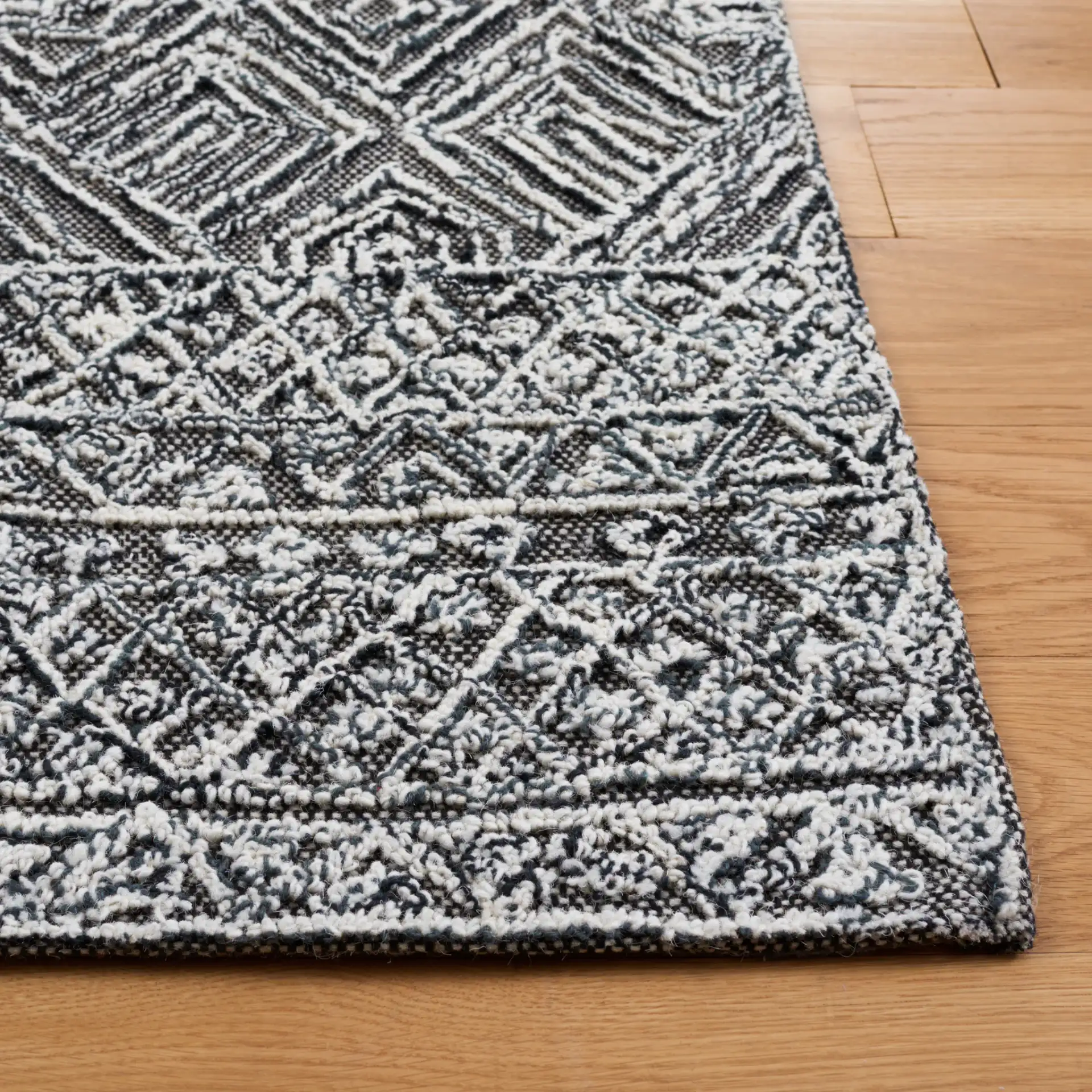 Textural Textual Nested Diamond Hand-Tufted Wool Rug in Black / Ivory in a styled room
