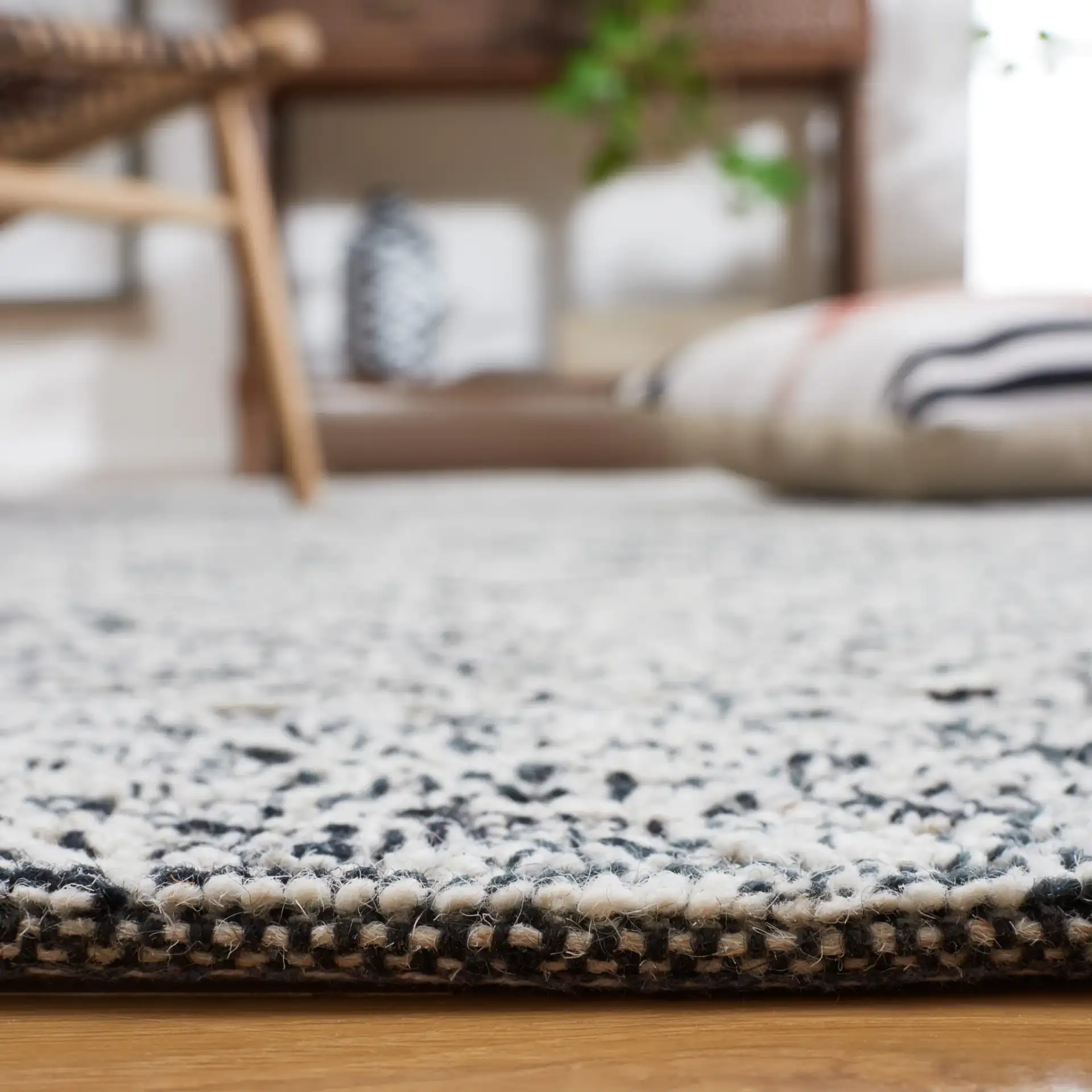 Textural Textual Nested Diamond Hand-Tufted Wool Rug in Black / Ivory in a styled room